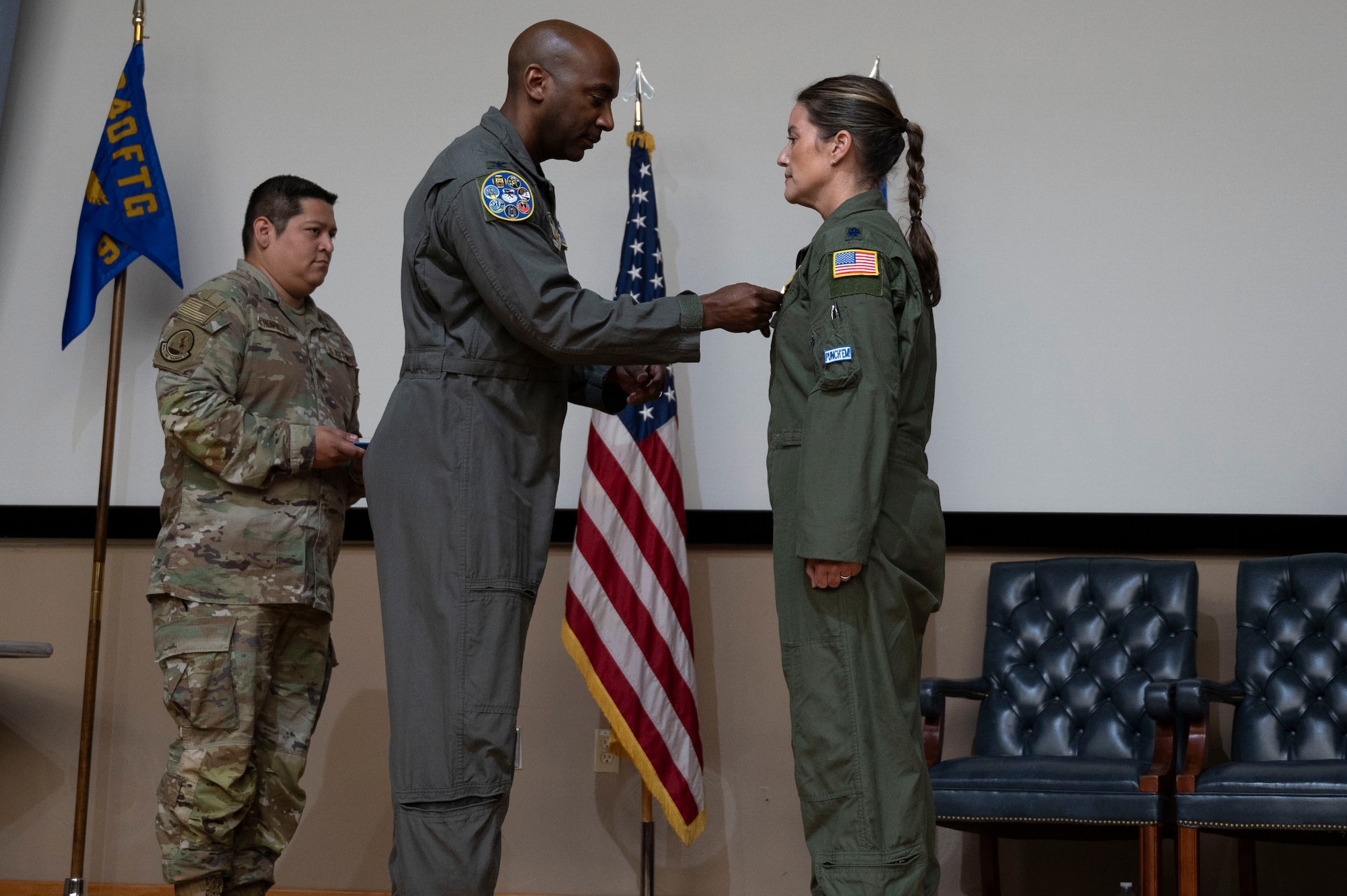 U.S. Air Force Col. Michael McMillan, 340th Flying Training Group director of operations, pins a Meritorious Service Medal onto Lt. Col. Christine Van Weezendonk’s flight suit, former 96th Flying Training Squadron commander, during the 96th FTS change of command ceremony at Laughlin Air Force Base, Texas, May 10, 2024. The Meritorious Service Medal was established as the counterpart of the Bronze Star Medal for the recognition of meritorious noncombatant service. (U.S. Air Force photo by Senior Airman Kailee Reynolds)