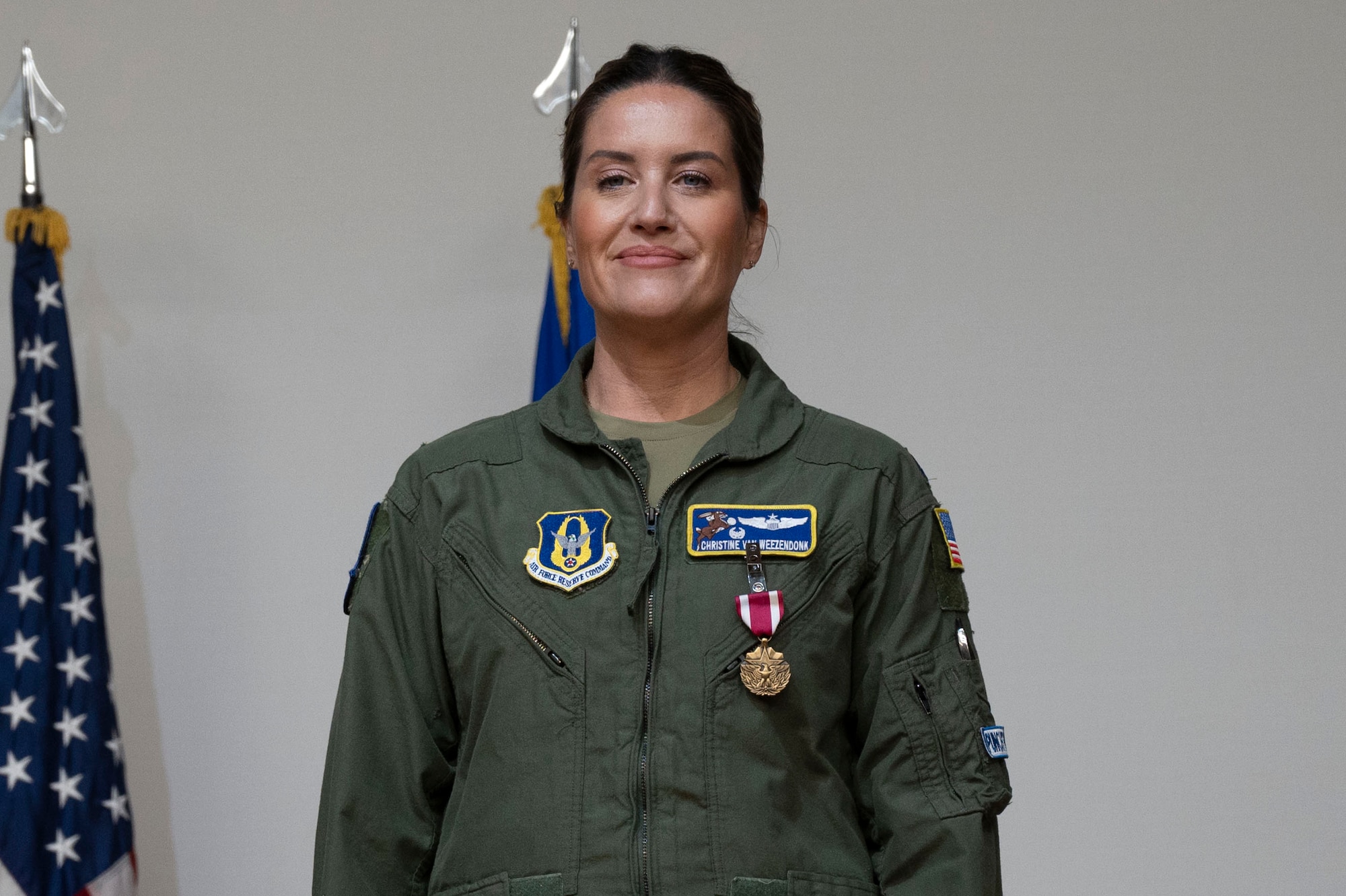 U.S. Air Force Lt. Col. Christine Van Weezendonk, former 96th Flying Training Squadron commander stands at attention after receiving the Meritorious Service Medal at the 96th FTS change of command ceremony at Laughlin Air Force Base, Texas, May 10, 2024. As commander, Weezendonk lead the recruitment, training and development of a 75-person Associate Reserve Instructor Pilot Corps and support personnel. (U.S. Air Force photo by Senior Airman Kailee Reynolds)