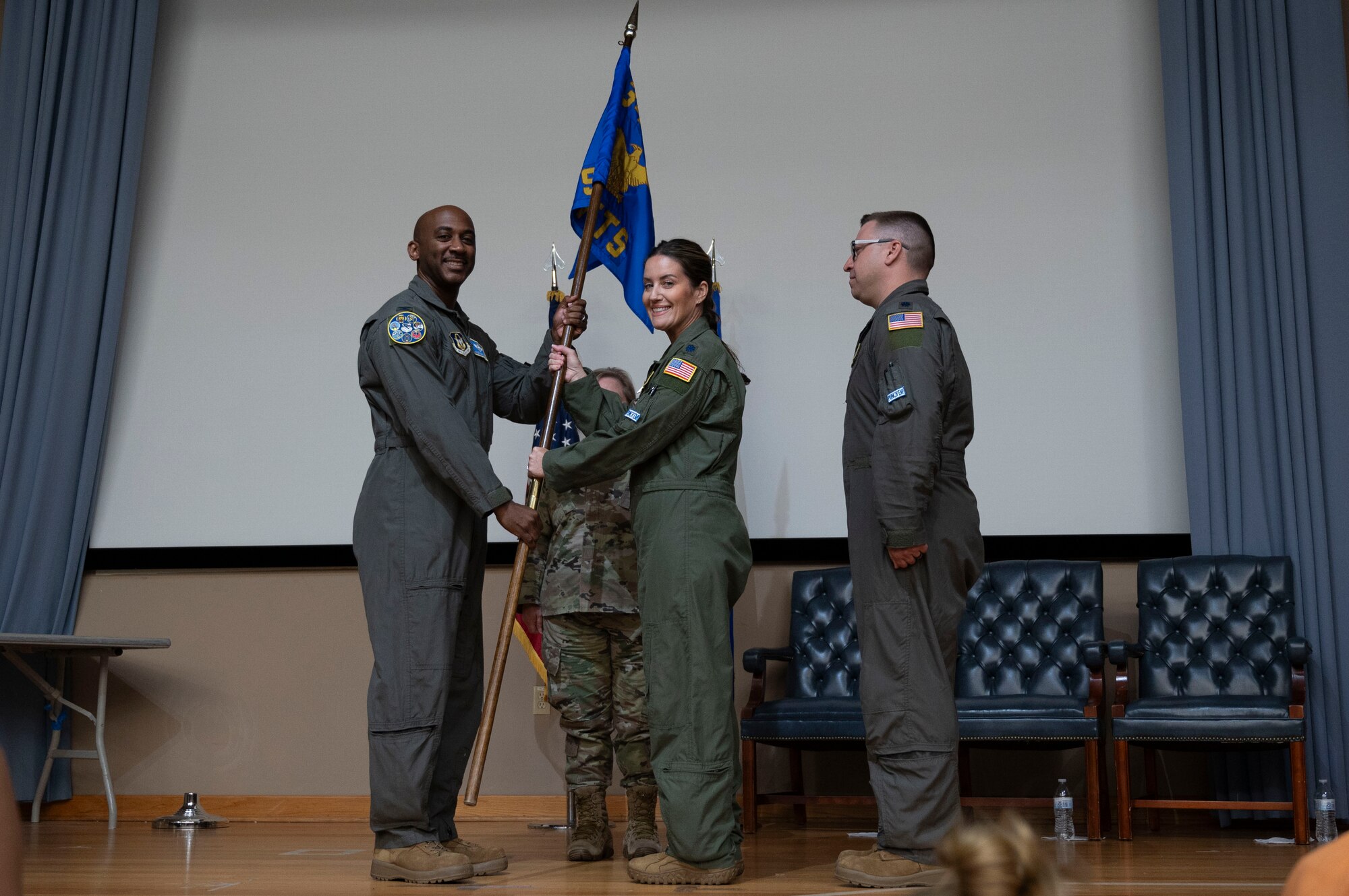 U.S. Air Force Lt. Col. Christine Van Weezendonk, former 96th Flying Training Squadron commander, turns over the 96th FTS guidon to Col. Michael McMillan, 340th Flying Training Group director of operations, during the 96th FTS change of command ceremony at Laughlin Air Force Base, Texas, May 10, 2024. As commander, Weezendonk lead the recruitment, training and development of a 75-person Associate Reserve Instructor Pilot Corps and support personnel. (U.S. Air Force photo by Senior Airman Kailee Reynolds)