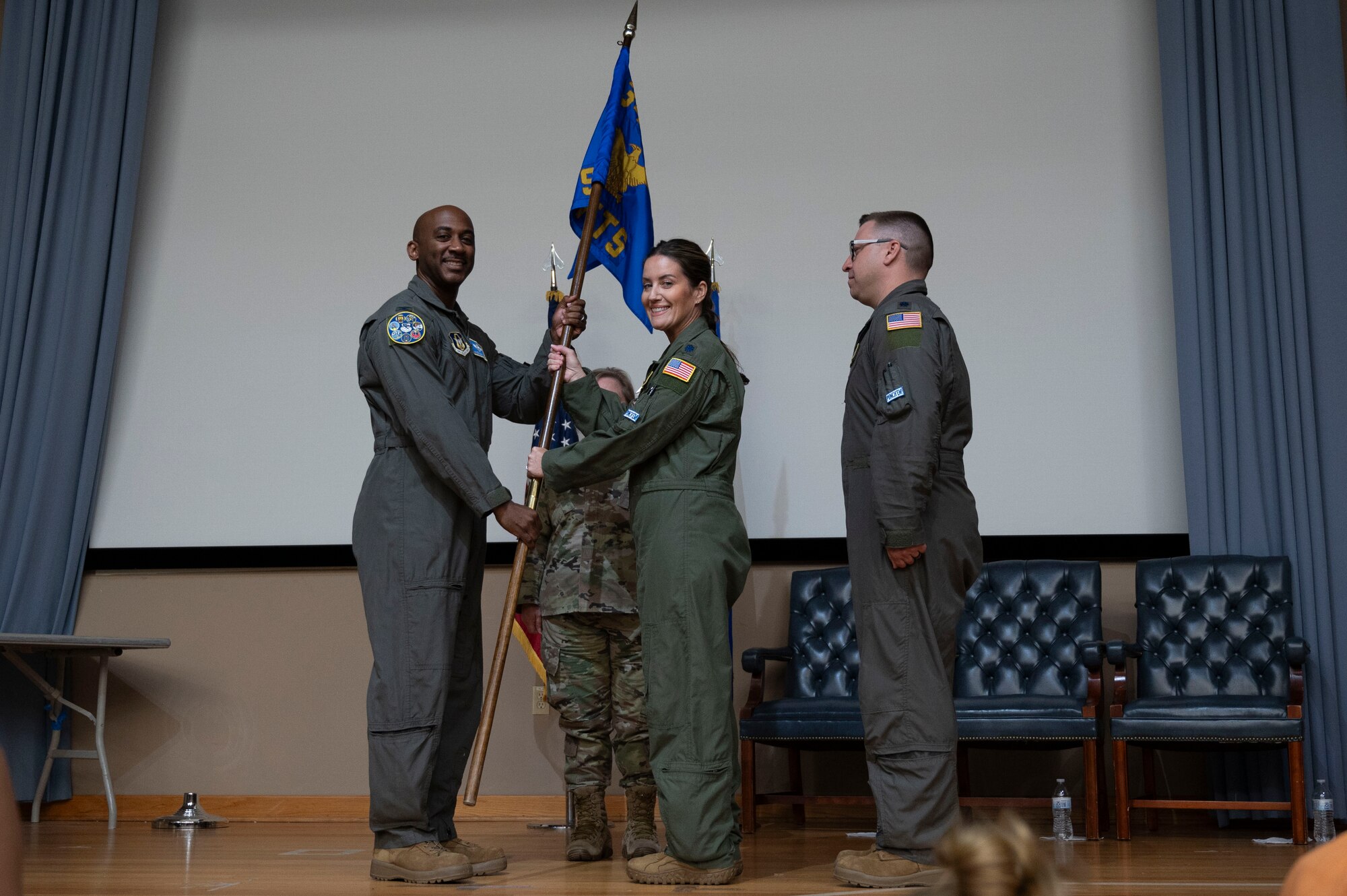 U.S. Air Force Lt. Col. Christine Van Weezendonk, former 96th Flying Training Squadron commander, turns over the 96th FTS guidon to Col. Michael McMillan, 340th Flying Training Group director of operations, during the 96th FTS change of command ceremony at Laughlin Air Force Base, Texas, May 10, 2024. As commander, Weezendonk lead the recruitment, training and development of a 75-person Associate Reserve Instructor Pilot Corps and support personnel. (U.S. Air Force photo by Senior Airman Kailee Reynolds)