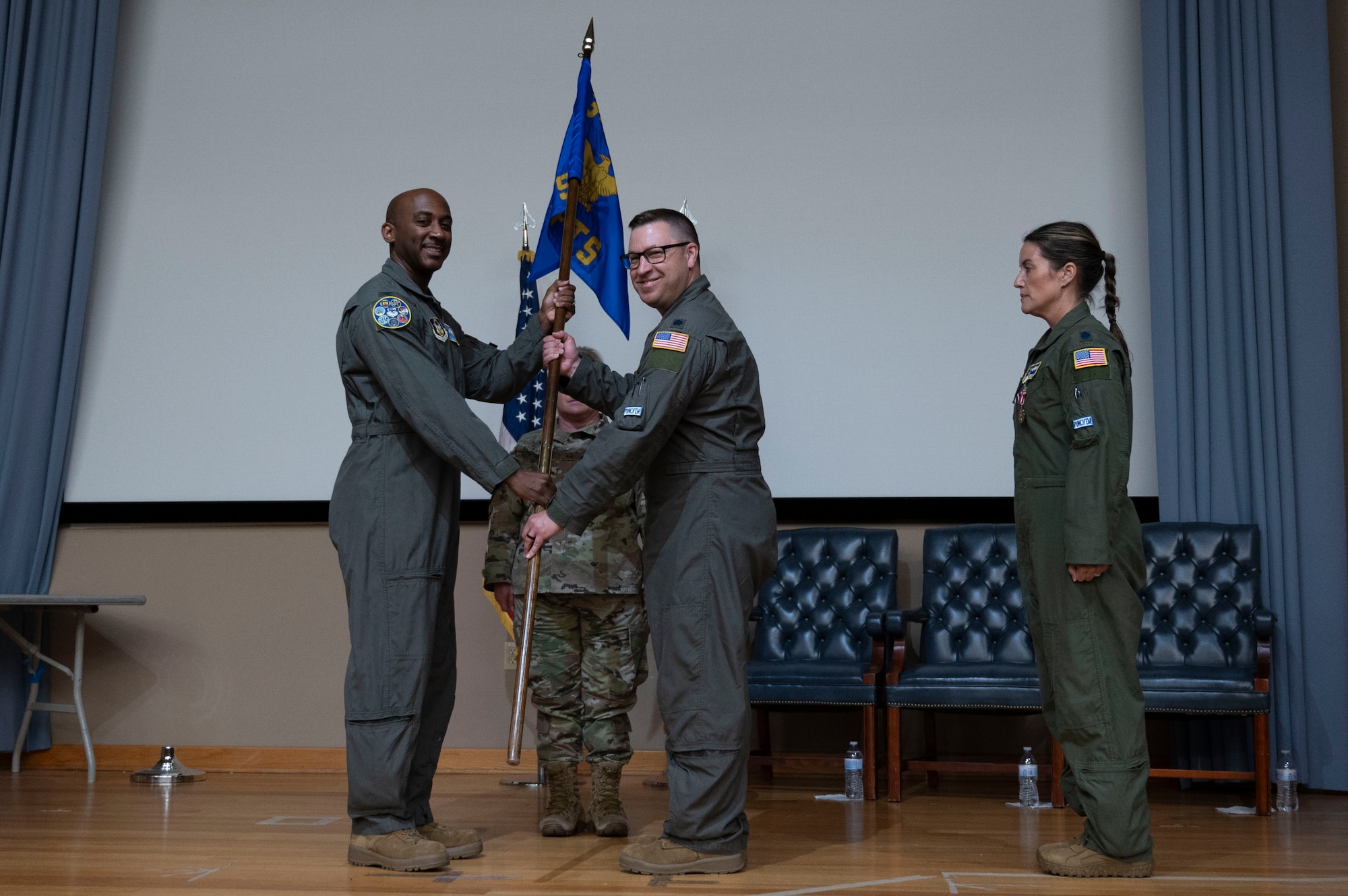 U.S. Air Force Lt. Col. Andrew Calhoun, current 96th Flying Training Squadron commander, accepts the 96th FTS guidon from Col. Michael McMillan, 340th Flying Training Group director of operations, during the 96th FTS change of command ceremony at Laughlin Air Force Base, Texas, May 10, 2024. The passing of the guidon to Calhoun signifies the acceptance of command of the 96th FTW. (U.S. Air Force photo by Senior Airman Kailee Reynolds)