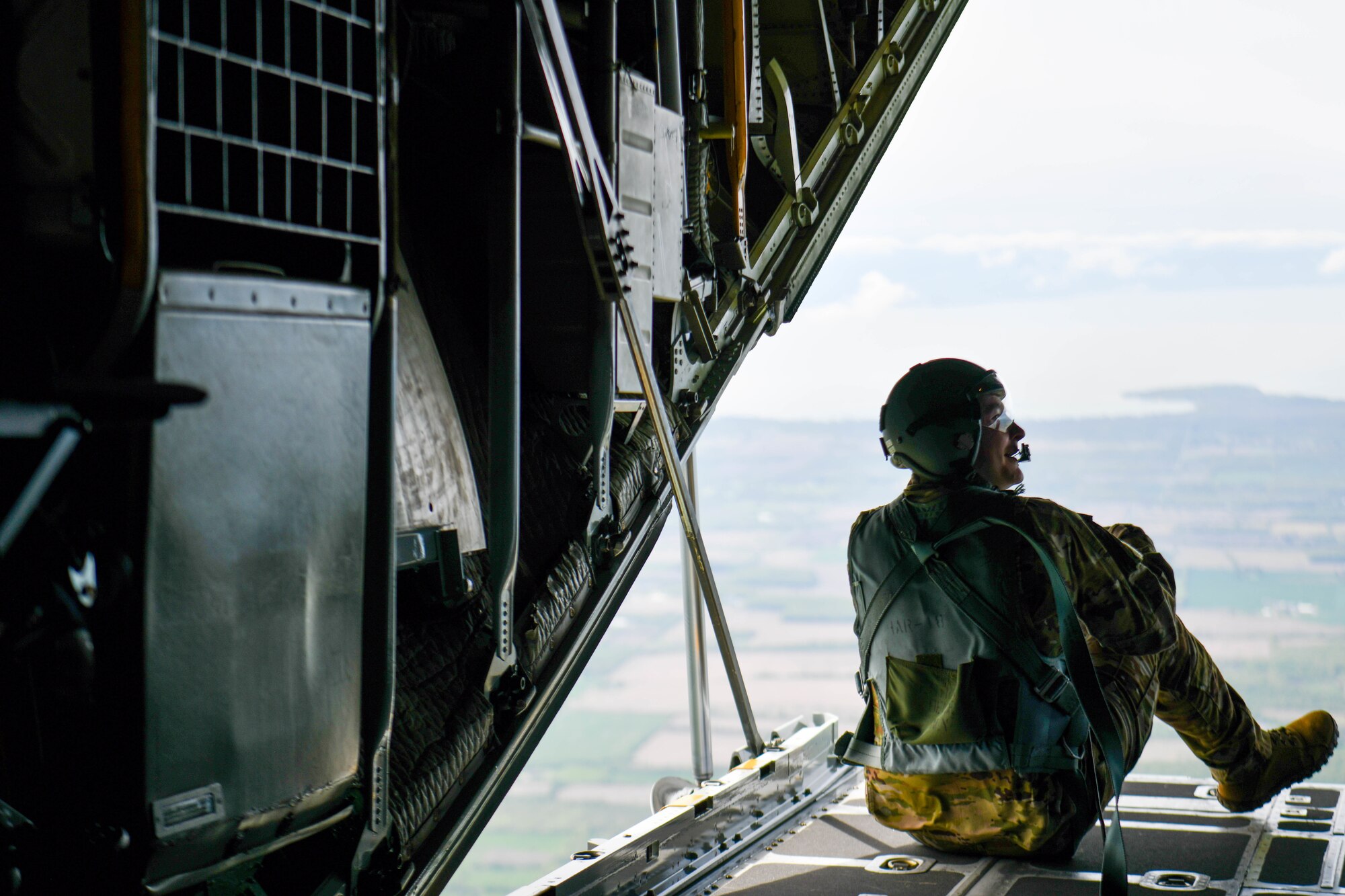 Senior Airman Jered Shaffer, a loadmaster assigned to the 757th Airlift Squadron, looks out the back of a C-130H Hercules aircraft during a local educator flight while circling above Niagara Falls, New York, May 10, 2024.