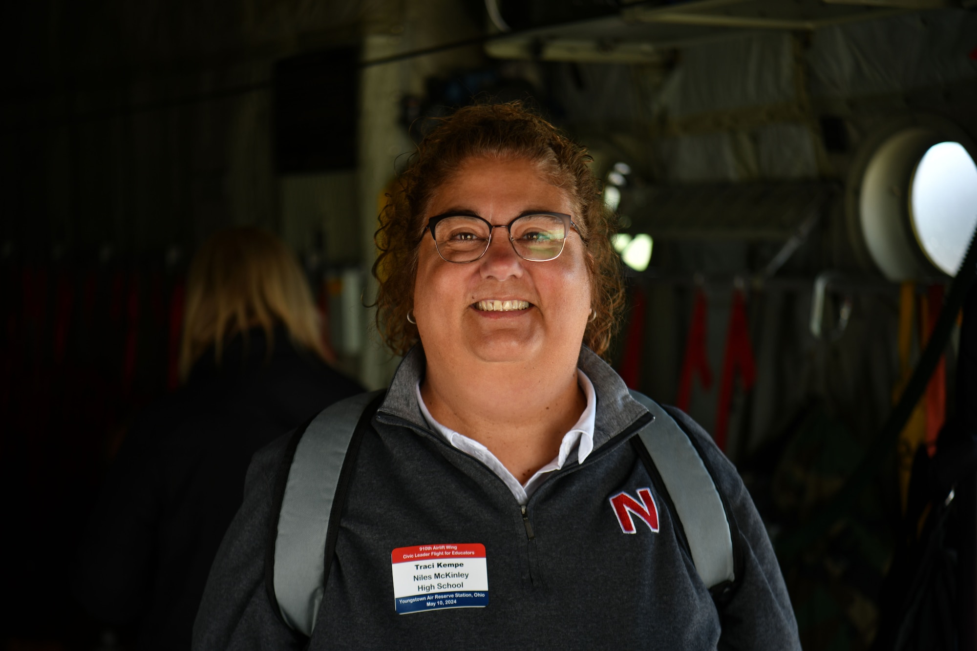 Traci Kempe, a Niles McKinley High School educator, poses aboard a C-130H Hercules before a local educator flight takeoff at Youngstown Air Reserve Station, Ohio, May 10, 2024.