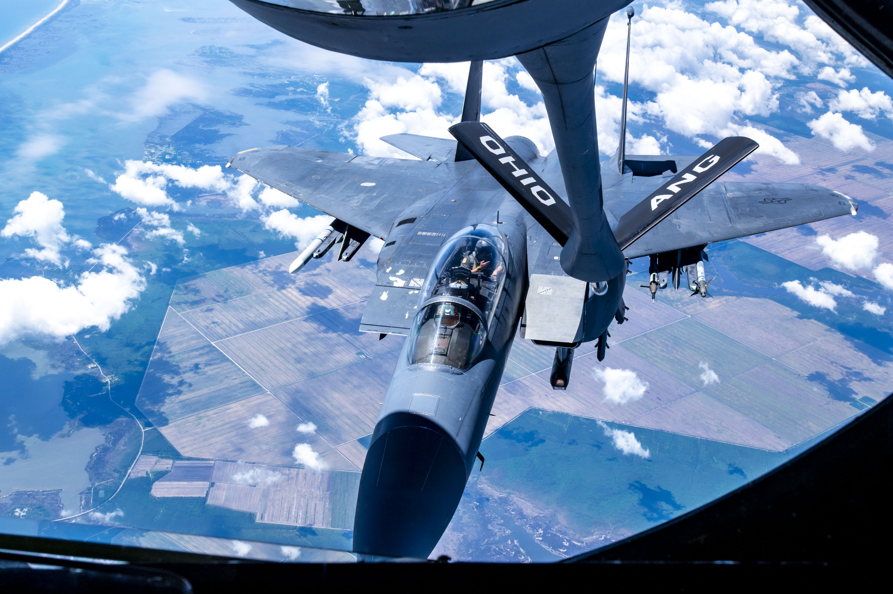 An F-15E Strike Eagle with the 4th Fighter Wing approaches a KC-135 Stratotanker from the 121st Air Refueling Wing to be refueled over the skies of North Carolina, May 7, 2024. The F-15E is a dual-role fighter designed to perform air-to-air and air-to-ground missions with an array of avionics and electronics systems that give it the capability to fight at low altitudes, day or night, and in all weather. (U.S. Air National Guard photo by Senior Airman Ivy Thomas)