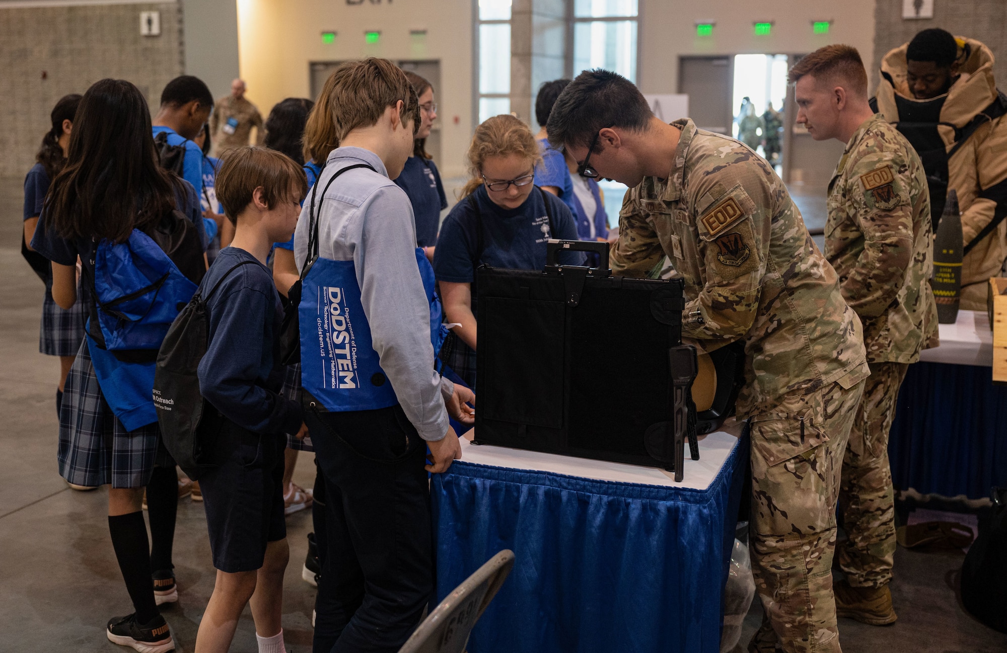 JBLE Airmen explain job specific items to local students.