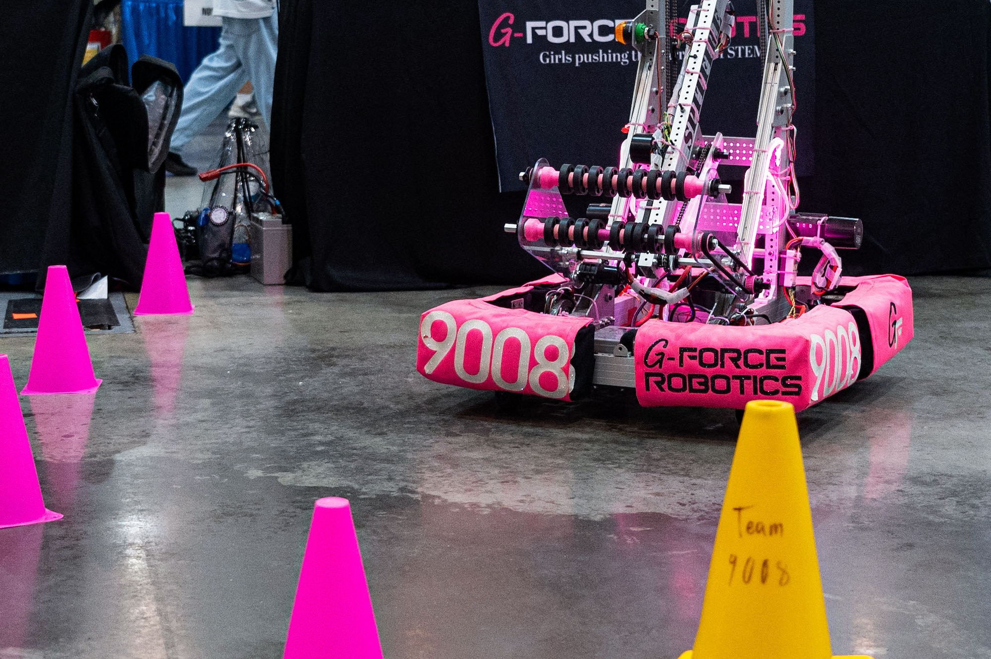 A robot maneuvering around cones.