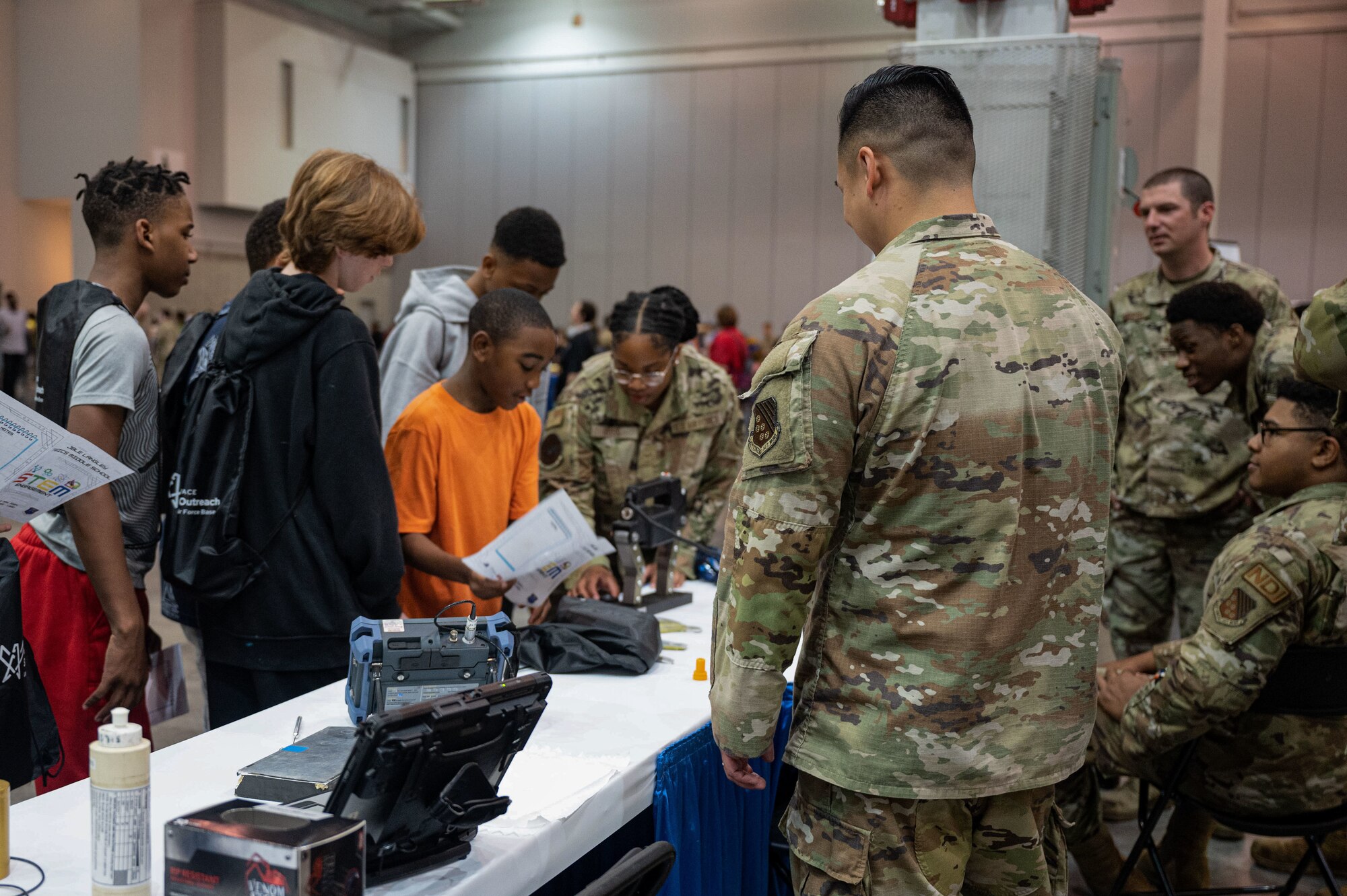 JBLE Airmen explaining job specific items to local students.