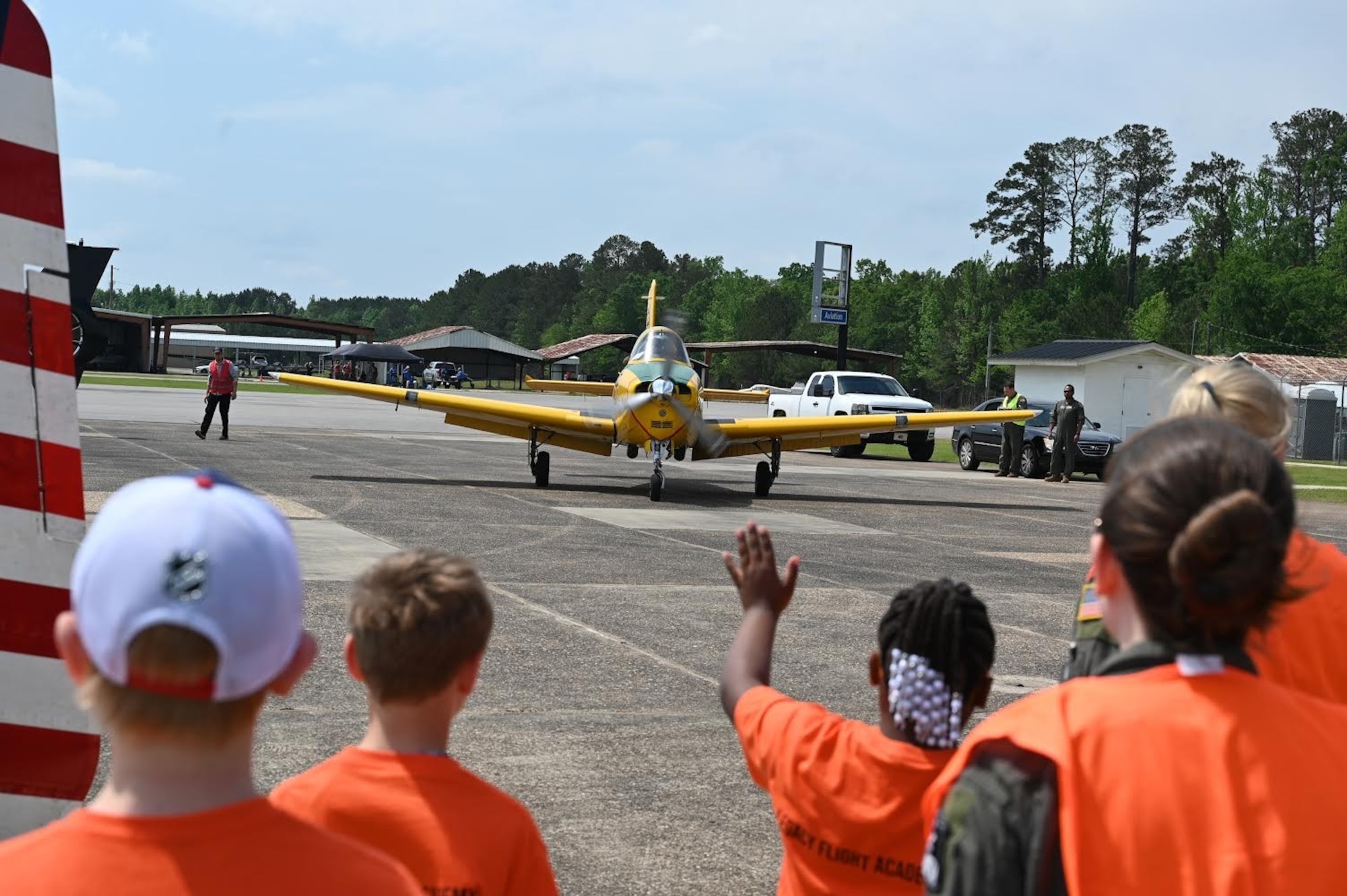 A participant of Eyes Above the Horizon waves at the Eyes Above the Horizon guest speaker as he arrives on April 27, 2024, at Columbus-Lowndes County Airport, Columbus, Mississippi. Attendees of Eyes Above the Horizon also attended a college and career fair and tried out flight simulators.