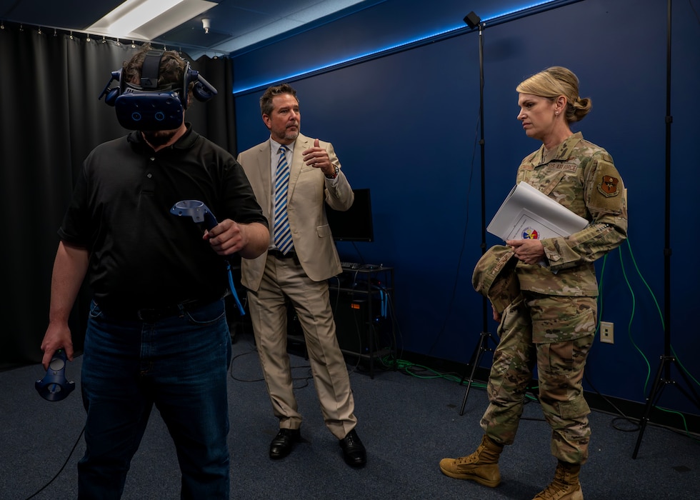 U.S. Air Force Maj. Gen. Michele Edmondson, Second Air Force commander, watches a demonstration of virtual reality gear used for training at Goodfellow Air Force Base, Texas, May 7, 2024. The VR headset is utilized to place trainees in specific real-life scenarios, boosting motivation and eagerness to learn the details of their jobs. (U.S. Air Force photo by Senior Airman Sarah Williams)