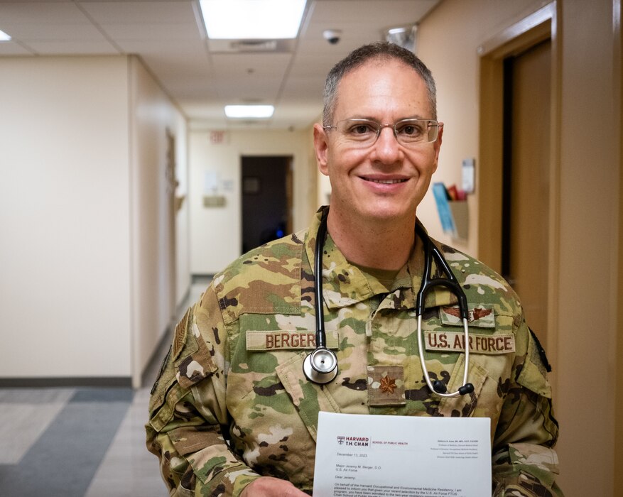 U.S. Air Force Maj. Jeremy Berger, 23rd Medical Group, chief of aerospace medicine, holds his acceptance letter to Harvard at Moody Air Force Base, Georgia, May 8, 2024. Berger was selected to attend Harvard’s Occupational and Environmental Medicine residency program due to his medical expertise in military medicine. (U.S. Air Force photo by 2nd Lt. Benjamin Williams)