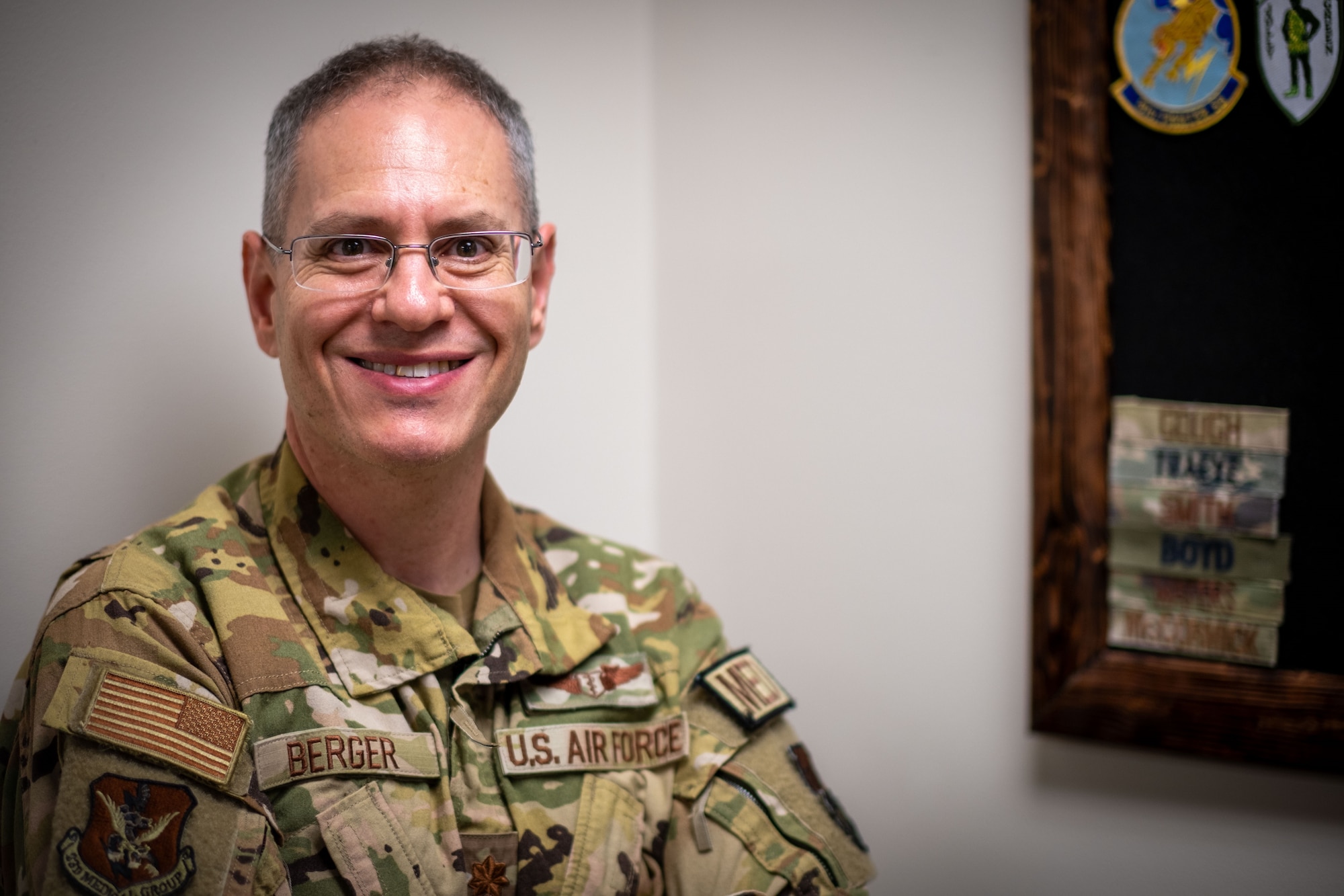 U.S. Air Force Maj. Jeremy Berger, 23rd Medical Group chief of aerospace medicine, smiles for a photo at Moody Air Force Base, Georgia, May 8, 2024. Berger fulfills the role of a flight surgeon, identifying, preventing and managing the physiological effects that arise from exposure to extreme environments to ensure Airmen remain in optimal health, allowing them to perform their duties effectively while in the air. (U.S. Air Force photo by 2nd Lt. Benjamin Williams)