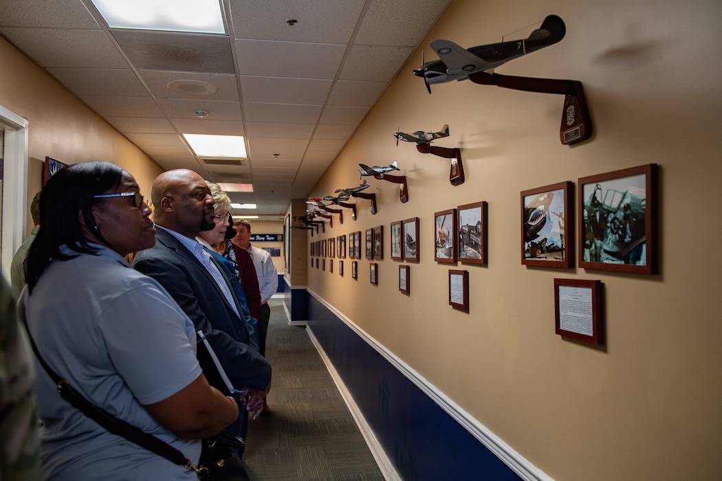 Members of the Moody School Board Liaison Committee look at historic photos during a base tour at Moody Air Force Base, Georgia, May 9, 2024. The annual base visit is designed to foster relationships with the committee and give local educators a firsthand look at the unique mission and operations of Team Moody Airmen. (U.S. Air Force Photo by Senior Airman Courtney Sebastianelli)