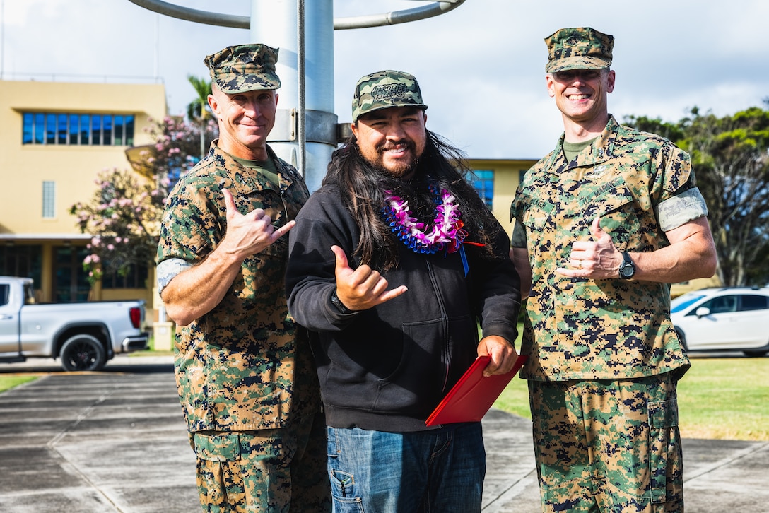 From left, U.S. Marine Corps Maj. Gen. Stephen Liszewski, commanding general, Marine Corps Installations Pacific, Kevin Lo, electronics mechanic, Marine Corps Base Hawaii Facilities Department, and Col. Jeremy Beaven, commanding officer, MCBH, pose for a photo during an awards ceremony at MCBH, April 23, 2024. The ceremony recognized civilian personnel for their work during the previous year. (U.S. Marine Corps photo by Sgt. Brandon Aultman)