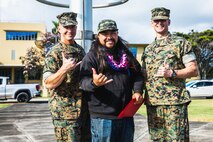 From left, U.S. Marine Corps Maj. Gen. Stephen Liszewski, commanding general, Marine Corps Installations Pacific, Kevin Lo, electronics mechanic, Marine Corps Base Hawaii Facilities Department, and Col. Jeremy Beaven, commanding officer, MCBH, pose for a photo during an awards ceremony at MCBH, April 23, 2024. The ceremony recognized civilian personnel for their work during the previous year. (U.S. Marine Corps photo by Sgt. Brandon Aultman)