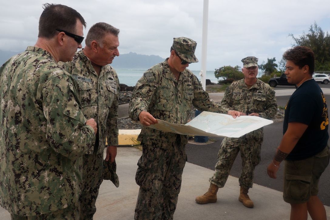 U.S. Coast Guardsmen with Port Security Unit 311, based in Long Beach, Calif., examine a map of areas to survey, Marine Corps Base Hawaii, April 25, 2024. Potential training areas were identified in preparation for Rim of the Pacific 2024, a biennial training exercise that gathers military forces from multiple nations for training that aims to strengthen cooperative relationships and bolster security across the world’s interconnected oceans. (U.S. Marine Corps photo by Lance Cpl. Carlos Daniel Chavez-Flores)
