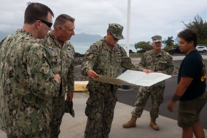 U.S. Coast Guardsmen with Port Security Unit 311, based in Long Beach, Calif., examine a map of areas to survey, Marine Corps Base Hawaii, April 25, 2024. Potential training areas were identified in preparation for Rim of the Pacific 2024, a biennial training exercise that gathers military forces from multiple nations for training that aims to strengthen cooperative relationships and bolster security across the world’s interconnected oceans. (U.S. Marine Corps photo by Lance Cpl. Carlos Daniel Chavez-Flores)