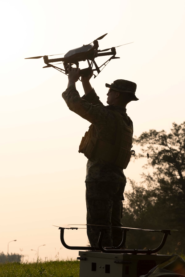 A U.S. Marine with 5th Air Naval Gunfire Liaison Company, III Marine Expeditionary Force Information Group, inspects a Hoverfly Livesky 6205 tethered unmanned aerial vehicle during Katana Strike 24 at Iejima, Okinawa, Japan, May 8, 2024. Katana Strike 24 is an annual exercise designed to further strengthen 5th ANGLICO's ability to conduct long-range communications and dynamic targeting cycles between joint ground, naval and aviation units in support of multi-domain operations. (U.S. Marine Corps photo by Cpl. Bridgette Rodriguez)