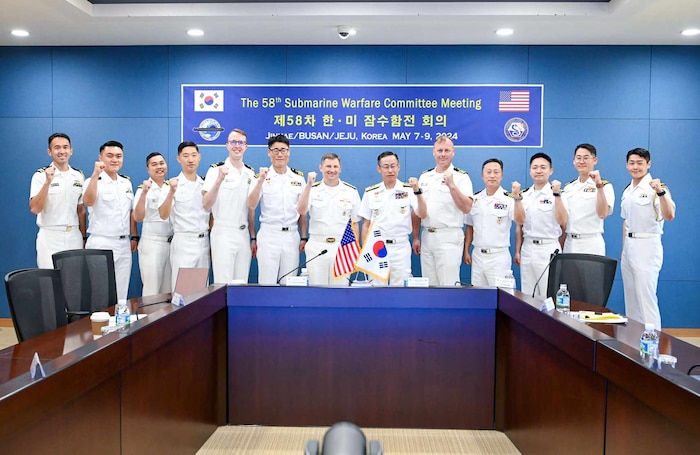 BUSAN Rear Adm. Chris Cavanaugh, Commander, Submarine Group 7, left, and Rear Adm. Kang Jeong-ho, Commander, ROK Navy Submarine Force, and their staffs pose for a photo at the Submarine Warfare Committee Meeting (SWCM) in Busan, South Korea. SWCM meetings have been held twice per year by U.S. and ROK submarine forces since 1994. During the meetings, submarine force units discuss ways to deepen partnerships and improve combined interoperability. (Photo courtesy of ROK Public Affairs)