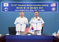 BUSAN Rear Adm. Chris Cavanaugh, Commander, Submarine Group 7, left, and Rear Adm. Kang Jeong-ho, Commander, ROK Navy Submarine Force, pose with the signed memorandum at the conclusion of the 58th semiannual Submarine Warfare Committee Meeting (SWCM) in Busan, South Korea. SWCM meetings have been held twice per year by U.S. and ROK submarine forces since 1994. During the meetings, submarine force units discuss ways to deepen partnerships and improve combined interoperability. (Photo courtesy of ROK Public Affairs)
