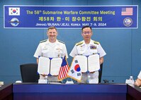 BUSAN Rear Adm. Chris Cavanaugh, Commander, Submarine Group 7, left, and Rear Adm. Kang Jeong-ho, Commander, ROK Navy Submarine Force, pose with the signed memorandum at the conclusion of the 58th semiannual Submarine Warfare Committee Meeting (SWCM) in Busan, South Korea. SWCM meetings have been held twice per year by U.S. and ROK submarine forces since 1994. During the meetings, submarine force units discuss ways to deepen partnerships and improve combined interoperability. (Photo courtesy of ROK Public Affairs)