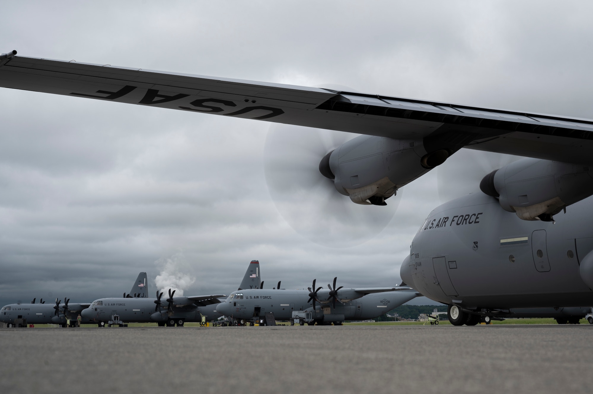 Multiple C-130J Super Hercules sit on a runway.