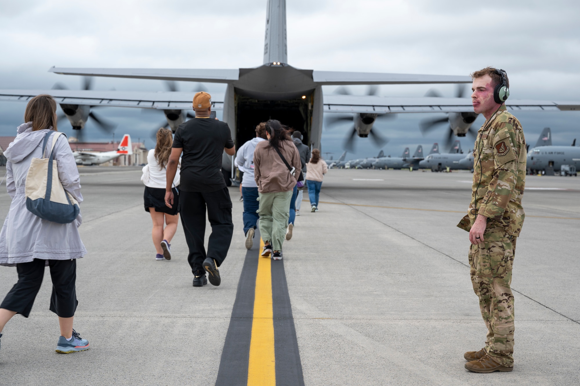 A loadmaster guides teaches onto a C-130J Super Hercules.