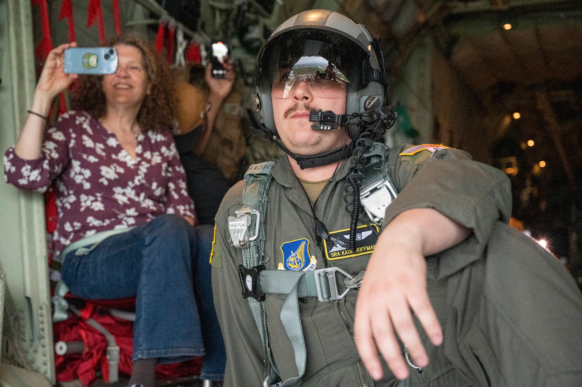 A loadmaster sits on the ramp of a C-130J Super Hercules.