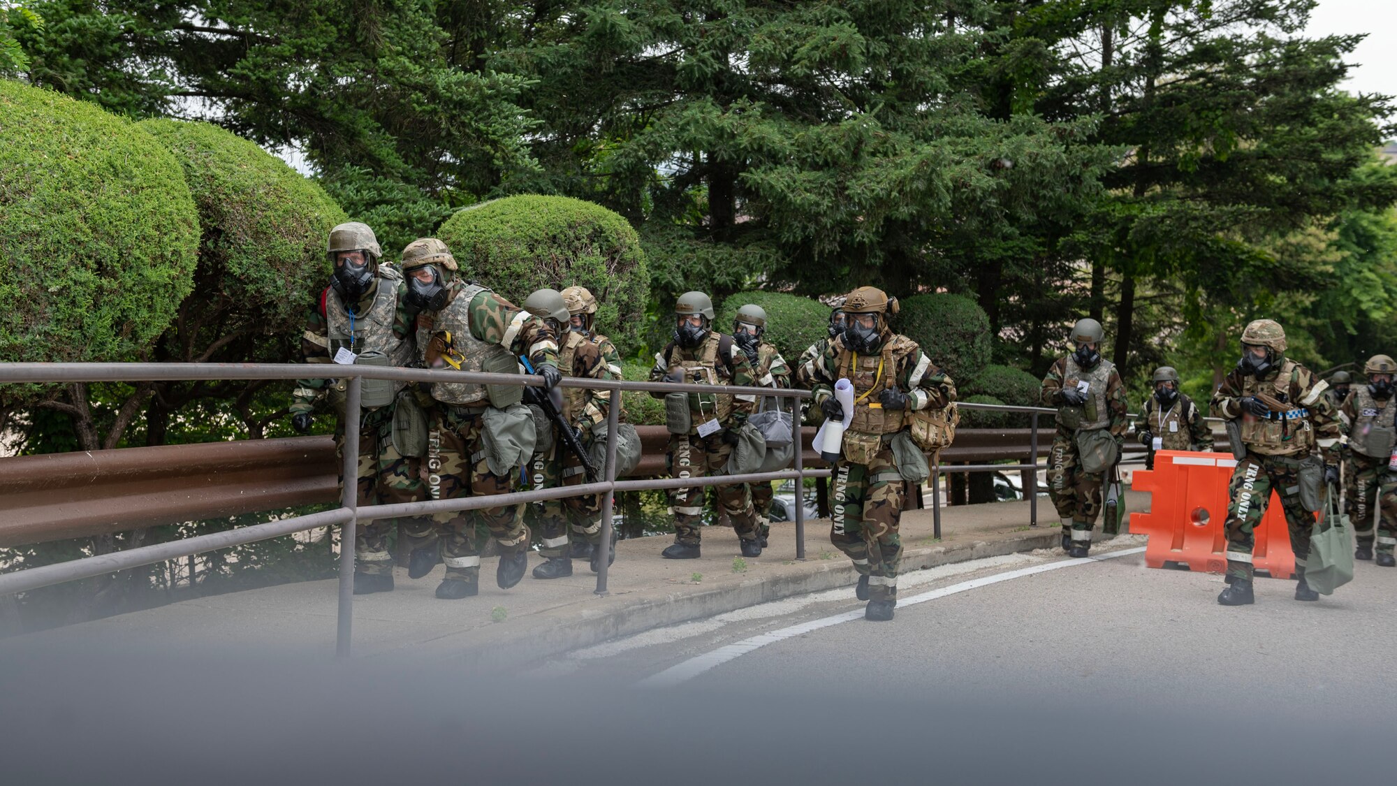 U.S. Air Force Airmen assigned to the 51st Fighter Wing conduct a “bug out” and move locations while in mission-oriented protective posture level four during Beverly Herd 24-1 at Osan Air Base, Republic of Korea, May 15, 2024. The training entailed members to evacuate their worksite, set up a temporary alternate location, and maintain the capability to maintain control of the central hub for wing-level situational awareness through all avenues. Routine training events like Beverly Herd are pivotal platforms for 51st Fighter Wing Airmen to refine their warfighting proficiencies through practical application, concurrently enhancing their ability to respond skillfully to contingencies. (U.S. Air Force photo by Staff Sgt. Aubree Owens)