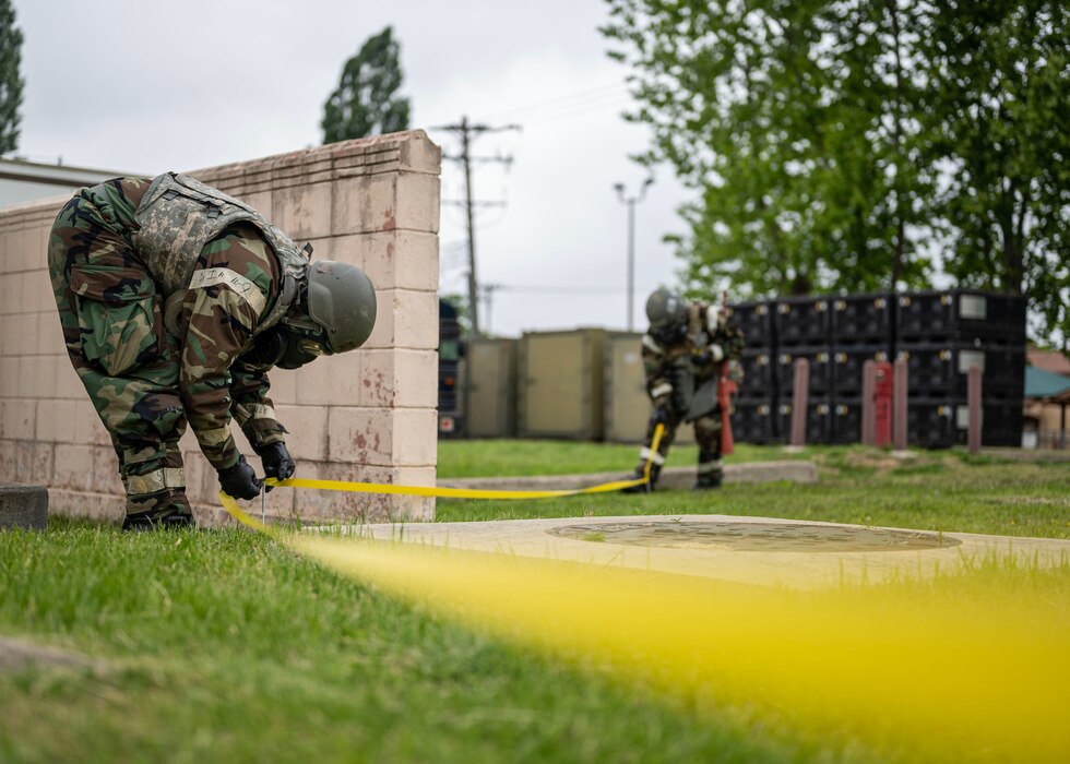 U.S. Air Force Airman 1st Class Veronyca Ortiz, 51st Fighter Wing emergency maintenance services team augmentee, cordons off the surrounding area of an inert ordnance in a training event during Beverly Herd 24-1 at Osan Air Base, Republic of Korea, May 15, 2024. The Airmen of the 51st Fighter Wing continuously train to maintain the high level of full-spectrum readiness required to execute the mission proficiently and effectively. Routine training events like Beverly Herd, are pivotal platforms for 51st Fighter Wing Airmen to refine their warfighting proficiencies through practical application, concurrently enhancing their ability to respond skillfully to contingencies. (U.S. Air Force photo by Staff Sgt. Aubree Owens)