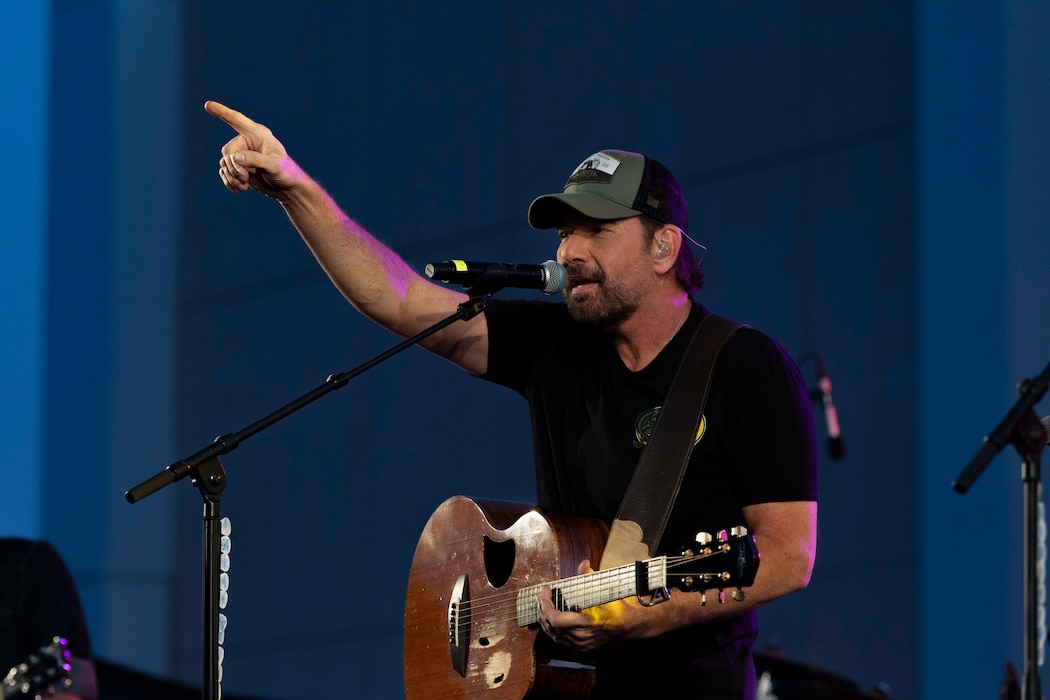Rodney Atkins, country music star, performs a song for personnel assigned to Naval Support Activity Souda Bay during a Morale, Welfare, and Recreation (MWR)-sponsored concert, titled Operation MWR, in the base Navy Exchange parking lot on May 12, 2024.