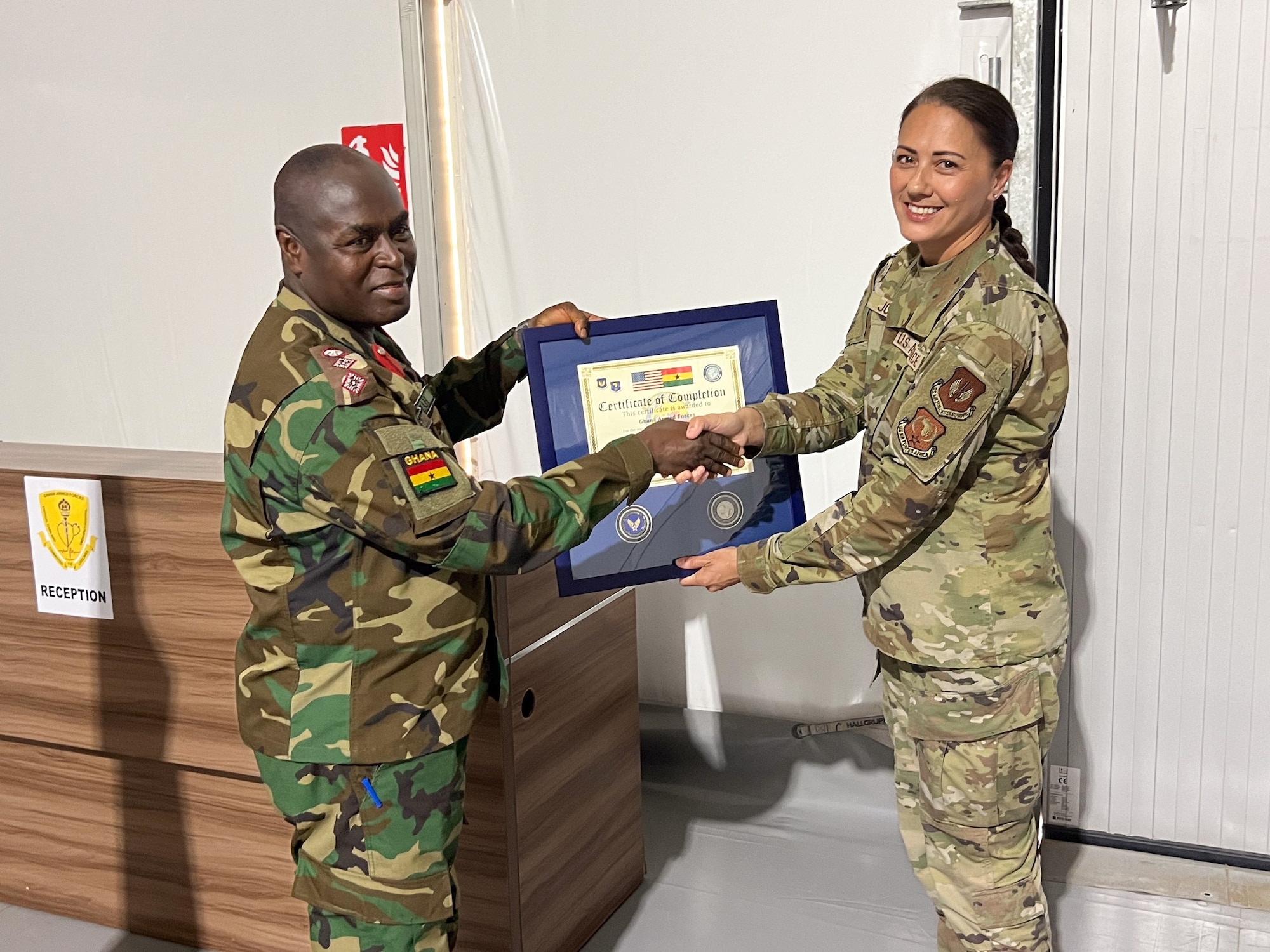 U.S. Air Force Lt. Col. Linda Jones, an international health specialist, presents a certificate to Ghana Armed Forces Col. George Boamah, GAF director of medical training, to mark the completion of a train-the-trainer event in Accra, Ghana, in early May. The training was part of the GAF’s pursuit of United Nations validation of its Aeromedical Evacuation Team capabilities. (Courtesy photo)