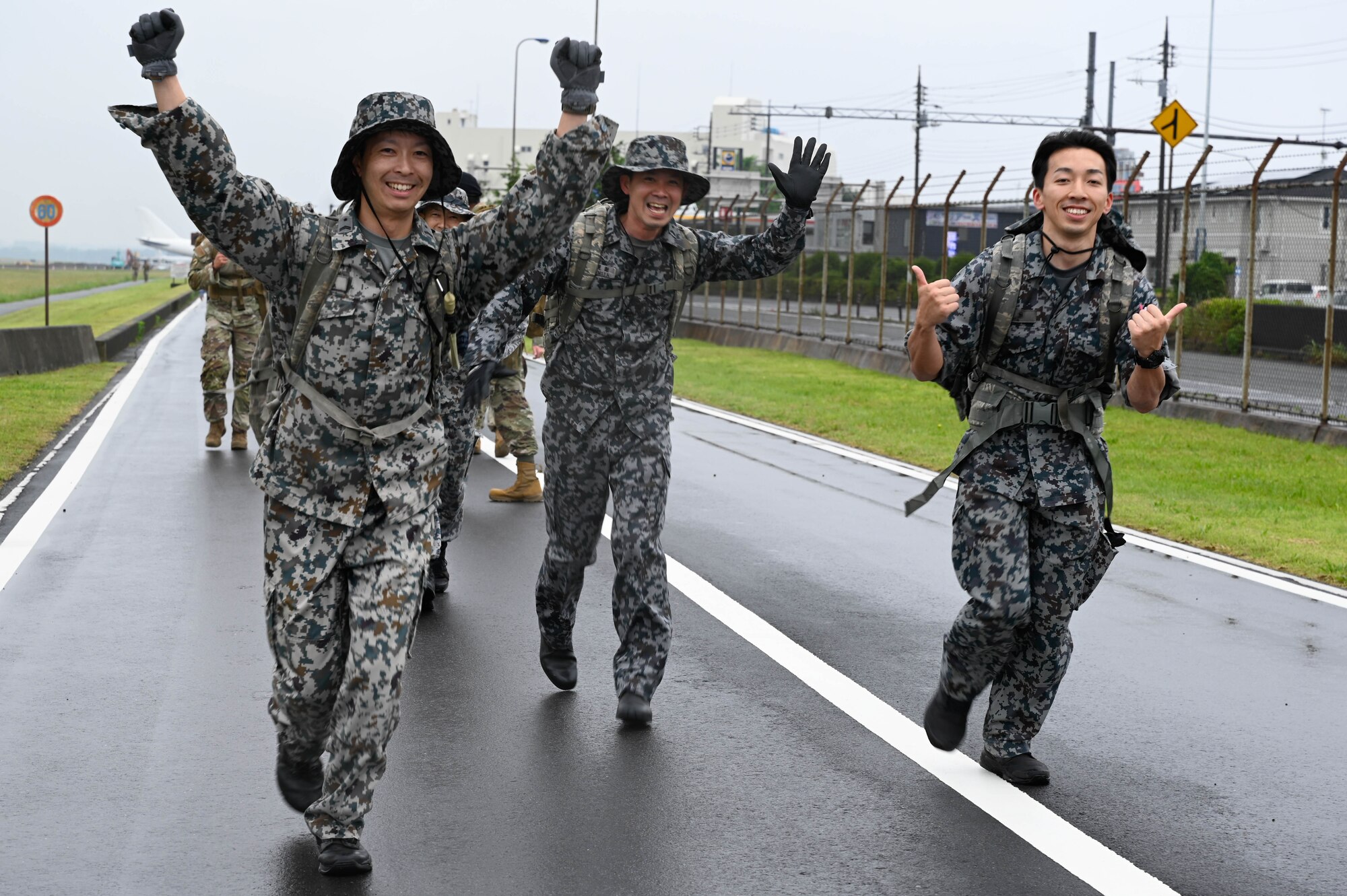 Japanese service members run together.