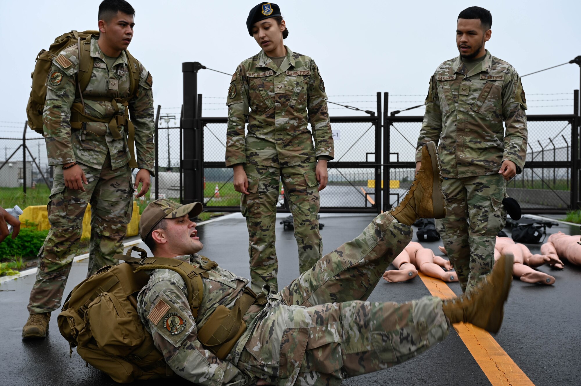 Airmen cheer on their teammate performing flutter kicks.