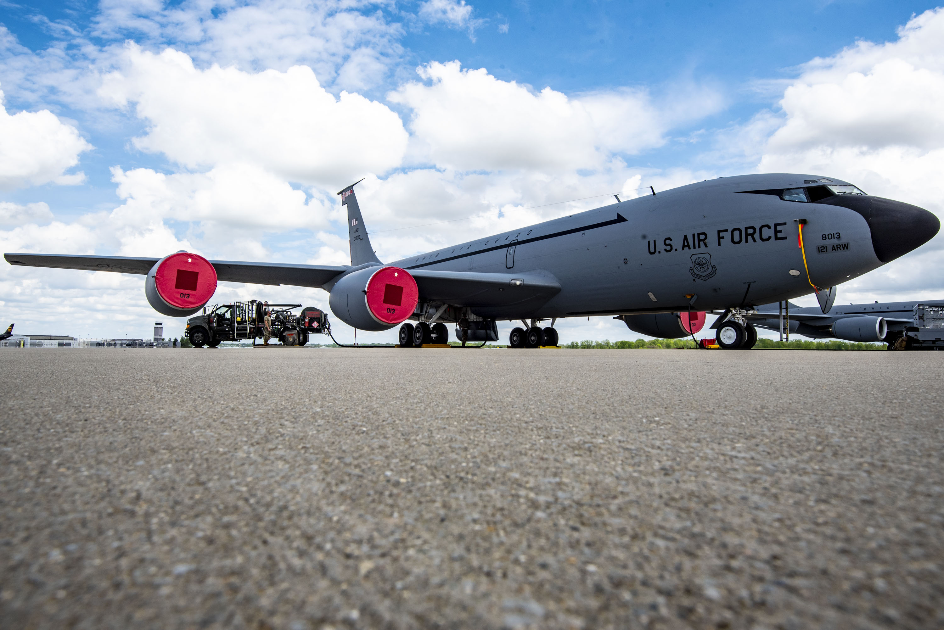 A KC-135 Stratotanker sits on the flight line while being refueled by a petroleum, oils, and lubricant Airman from the 121st Air Refueling Wing at Rickenbacker Air National Guard Base, Columbus, Ohio, April 30, 2024. Before putting the fuel onto the KC-135 Stratotanker, POL tests fuel samples to ensure the fuel is free of contaminants and ready to be offloaded onto the jet, which is then used to accomplish aerial refueling missions. (U.S. Air National Guard photo by Senior Airman Ivy Thomas)