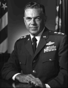 Lieutenant General George S. Boylan poses for an official Air Force photo.  He is in his dress uniform with the rank of a three-star general.