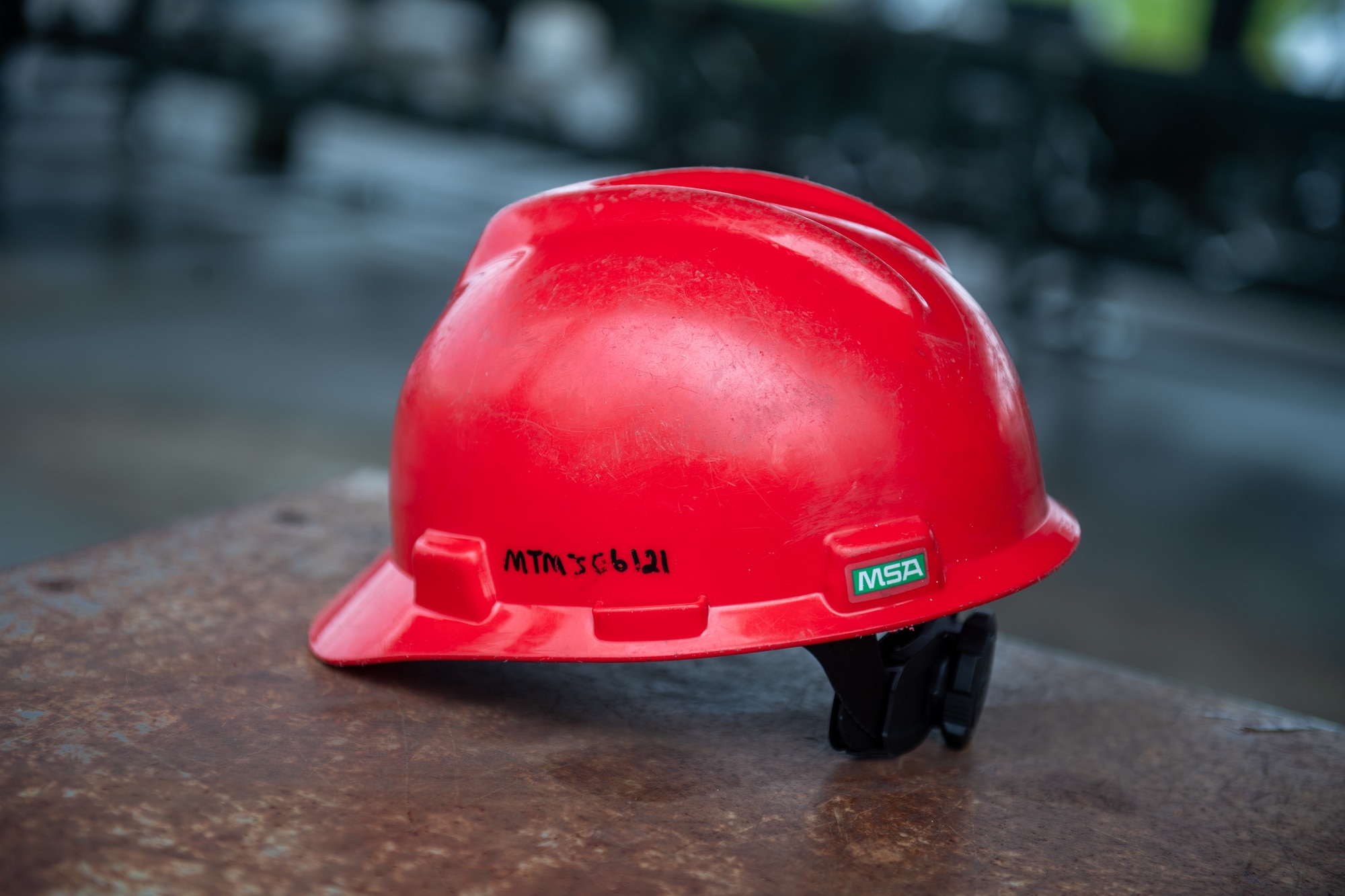 A 23rd Munitions Squadron safety helmet sits on a table at Moody Air Force Base, Georgia, May 14, 2024. While working with ammunition, Airmen must take all safety precautions and be aware of their environment. (U.S. Air Force photo by Airman 1st Class Cade Ellis)