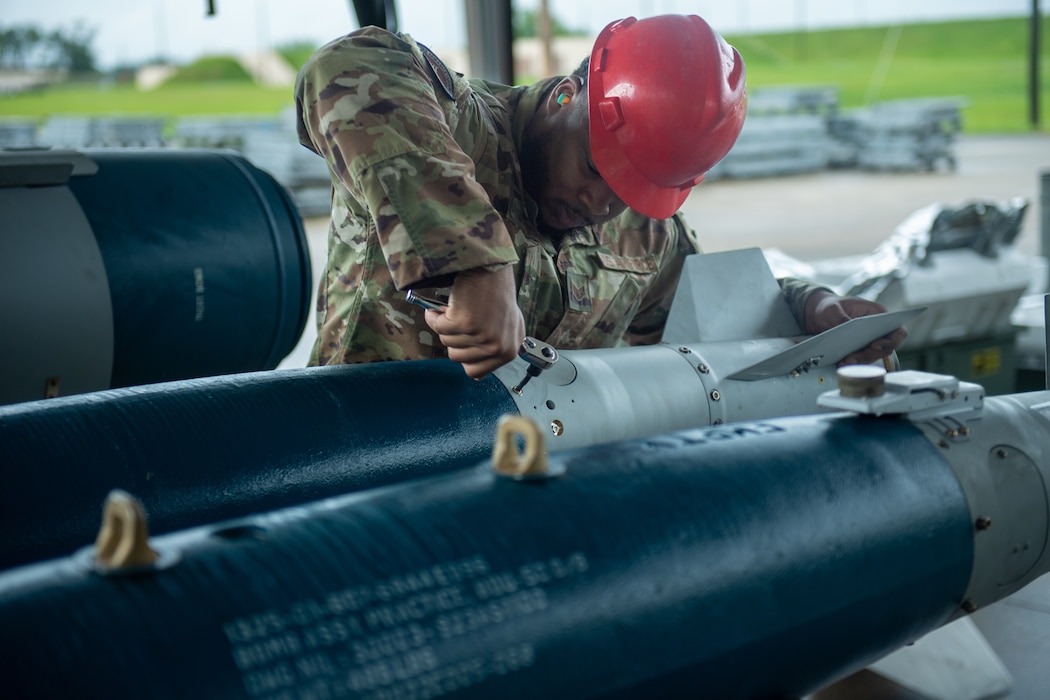 An Airman from the 23rd Munitions Squadron attaches the tail of a GBU 12 at Moody Air Force Base, Georgia, May 14, 2024. The tail of the explosives is an important part in hitting the target because it protects the tracking system so that it can hit the target. (U.S. Air Force photo by Airman 1st Class Cade Ellis)