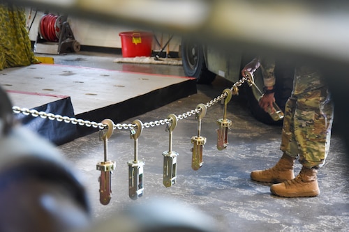 Chaining devices for aircraft are hung on a chain to represent fallen Port Dawgs.