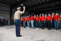 U.S. Marine Corps Capt. Jacob Layton, the executive officer of Recruiting Station Kansas City conducts the oath of enlistment during the 9th Annual Friends In Service of Heroes Armed Forces Celebration Day at New Century, Kansas on May 4th, 2024. Sgt.Maj. Ruiz visited the current command and the future officers and enlisted Marines of Recruiting Station Kansas City prior to giving remarks at the AFD event. AFD, annually conducted by FISH, serves as an event to recognize and honor service members and veterans who have chosen duty, honor, and country to protect our freedoms. (U.S. Marine Corps photo by Sgt. Alexis Moradian)