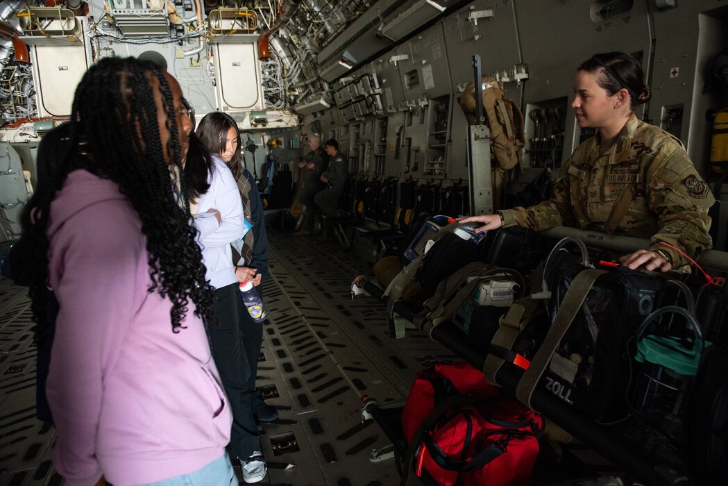 Airman speaks to students on a C-17
