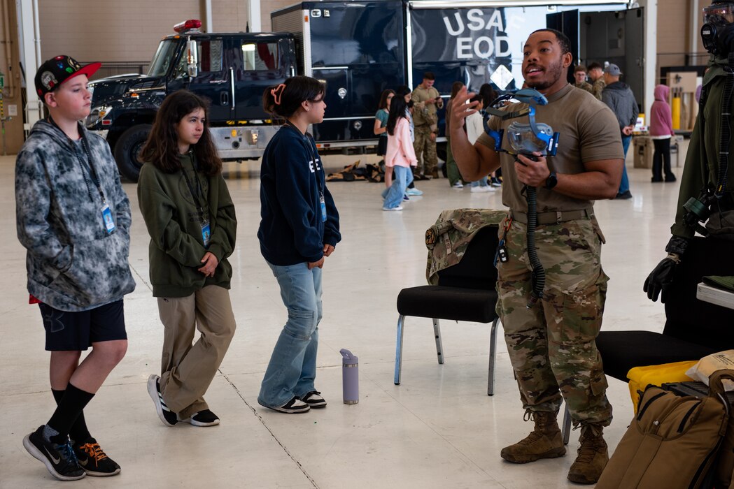Airman speaks with students during Career Day