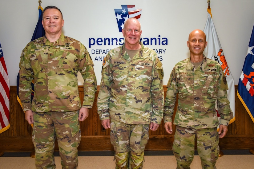 Pennsylvania Adjutant General Maj. Gen. Mark Schindler, center, poses for a photo with Brig. Gen. John Pippy, left, and Brig. Gen. Terrence Koudelka Jr., right, May 15, 2024, at Fort Indiantown Gap, Pa. Koudelka was recently appointed deputy adjutant general - Air of the Pennsylvania National Guard, and Pippy was appointed director of the joint staff. (Pennsylvania National Guard photo by Tom Cherry)