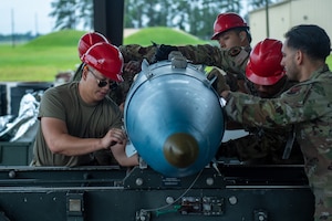 Airmen from the 23rd Munitions Squadron work on a GBU 31 V1 at Moody Air Force Base, Georgia, May 14, 2024.Airmen from Robins AFB attended the training to learn how to safely and efficiently build munitions. (U.S. Air Force photo by Airman 1st Class Cade Ellis)