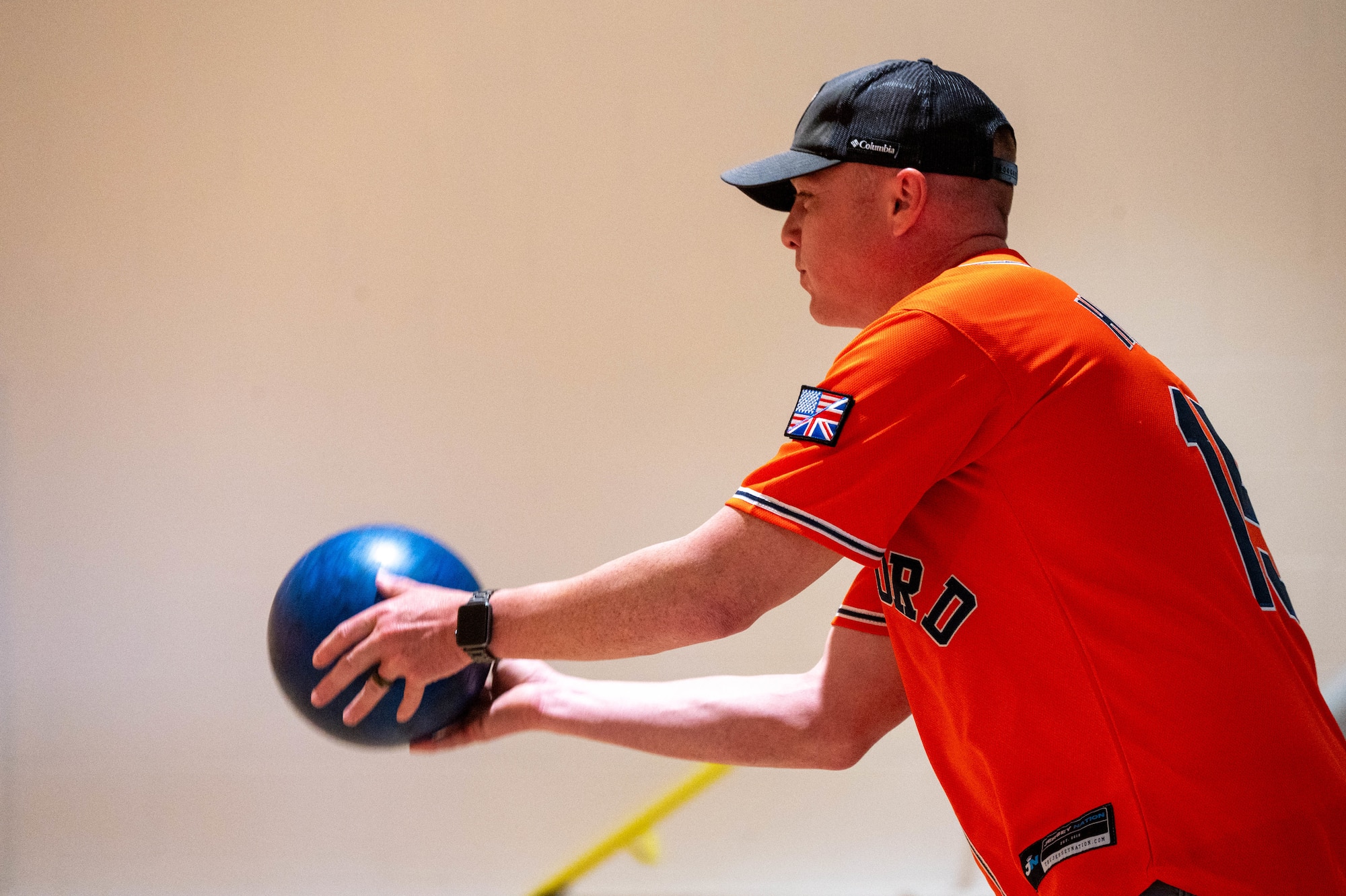 An Airman prepares to release a bowling ball