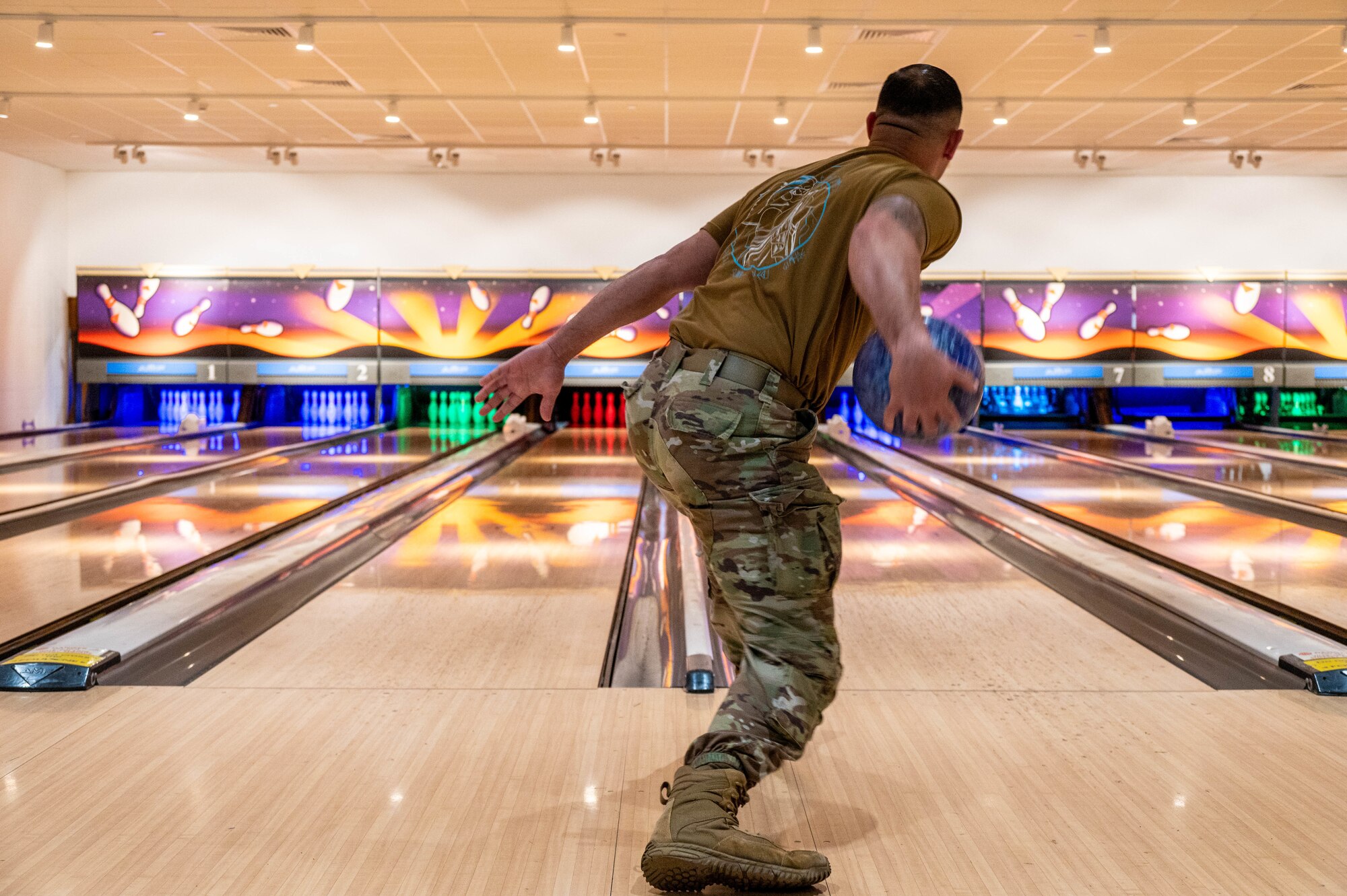 An Airman prepares to release a bowling ball