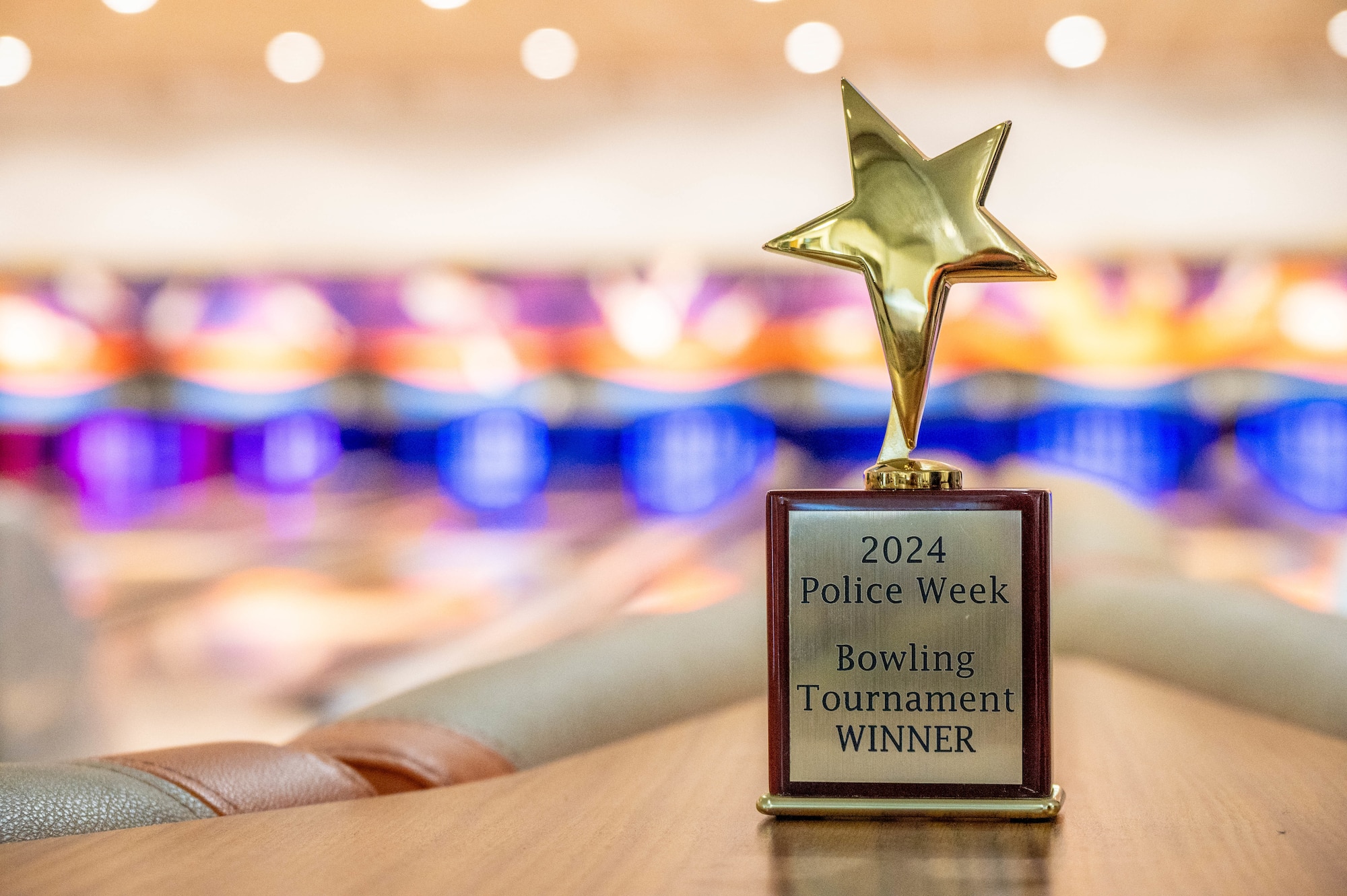 A trophy in the shape of a star reads "2024 Police Week Bowling Tournament Winner"
