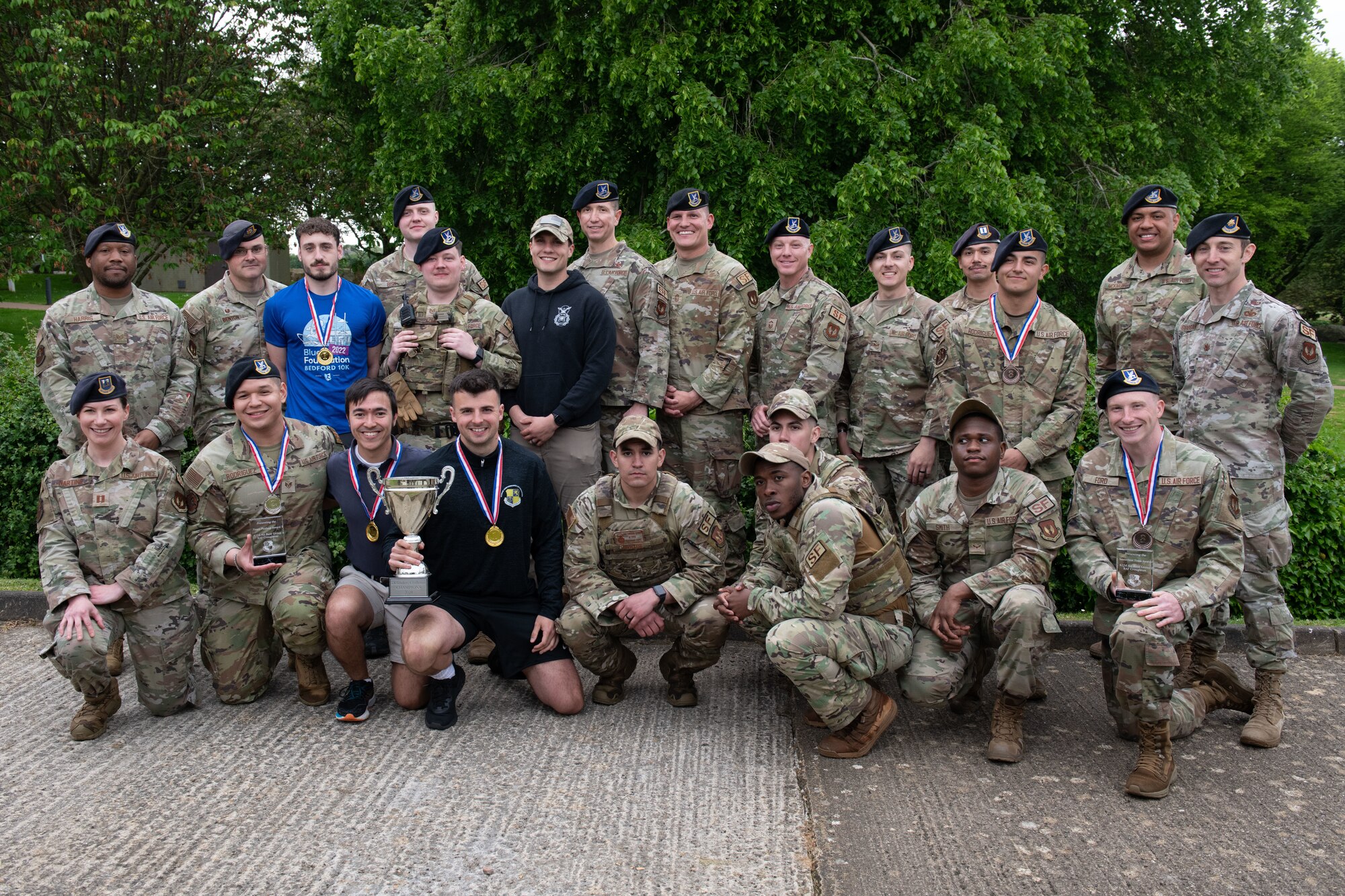 Defenders and civilian participants pose for a group photo