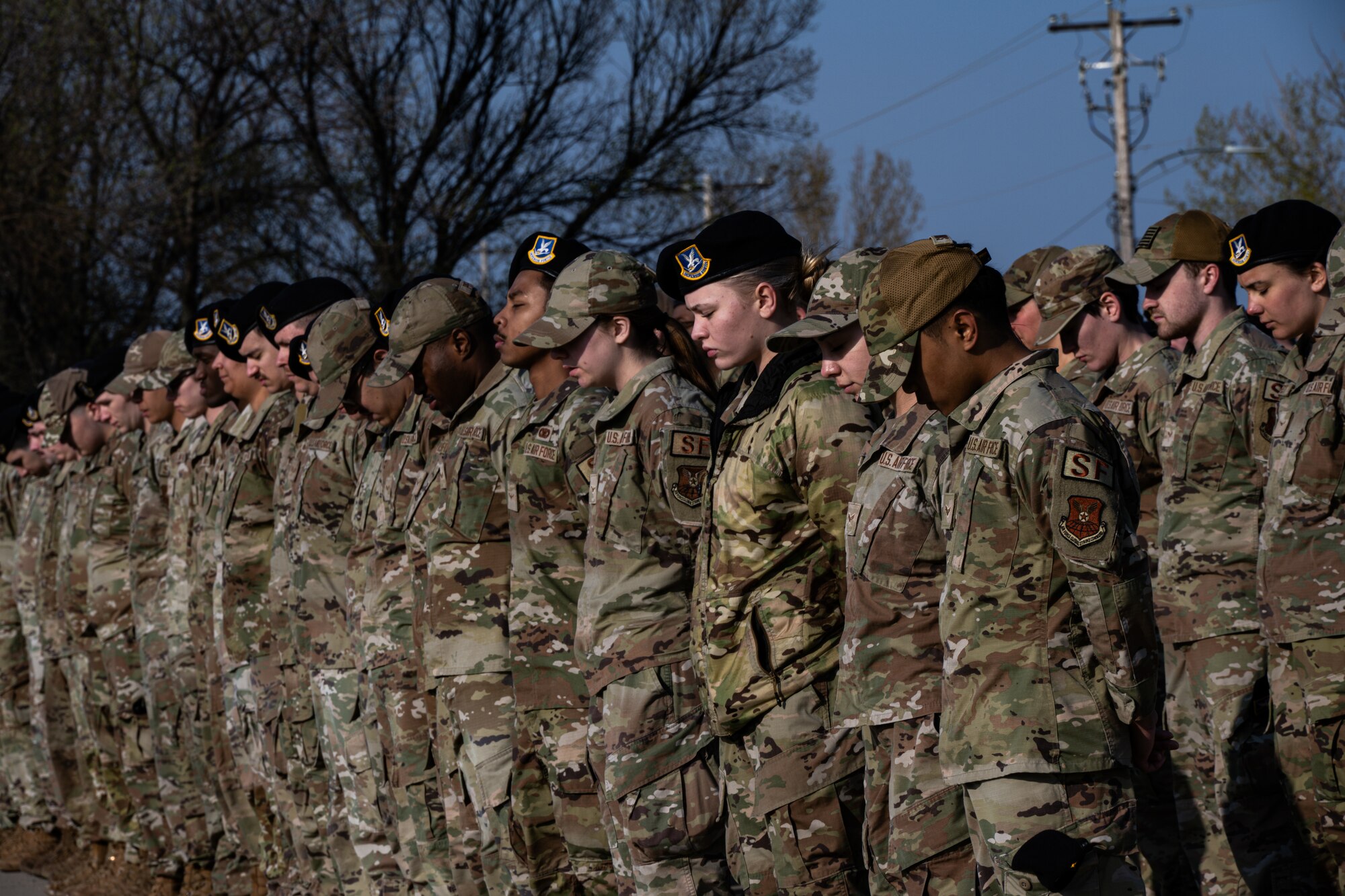 Team Minot’s Security Forces Airmen bow their heads in prayer during the 2024 National Police Week opening ceremony at Minot Air Force Base, North Dakota, May 13, 2024. National Police Week is geared towards honoring all fallen officers and defenders, including, U.S. Air Force Security Forces, U.S. Navy Military Police and the Office of Special Investigations. (U.S. Air Force photo by Airman 1st Class Alyssa Bankston)