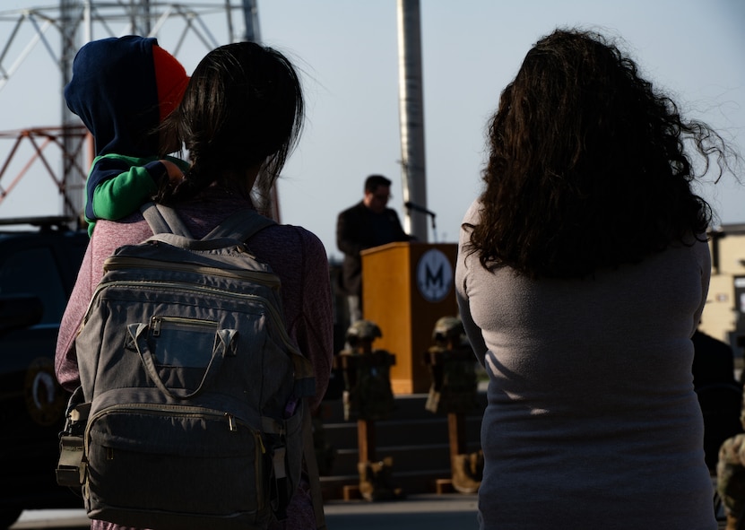 Airmen and their families attend the 2024 National Police Week opening ceremony at Minot Air Force Base, North Dakota, May 13, 2024. National Police Week occurs annually to honor military and civilian police officers who have lost their lives in the line of duty. (U.S. Air Force photo by Airman 1st Class Alyssa Bankston)