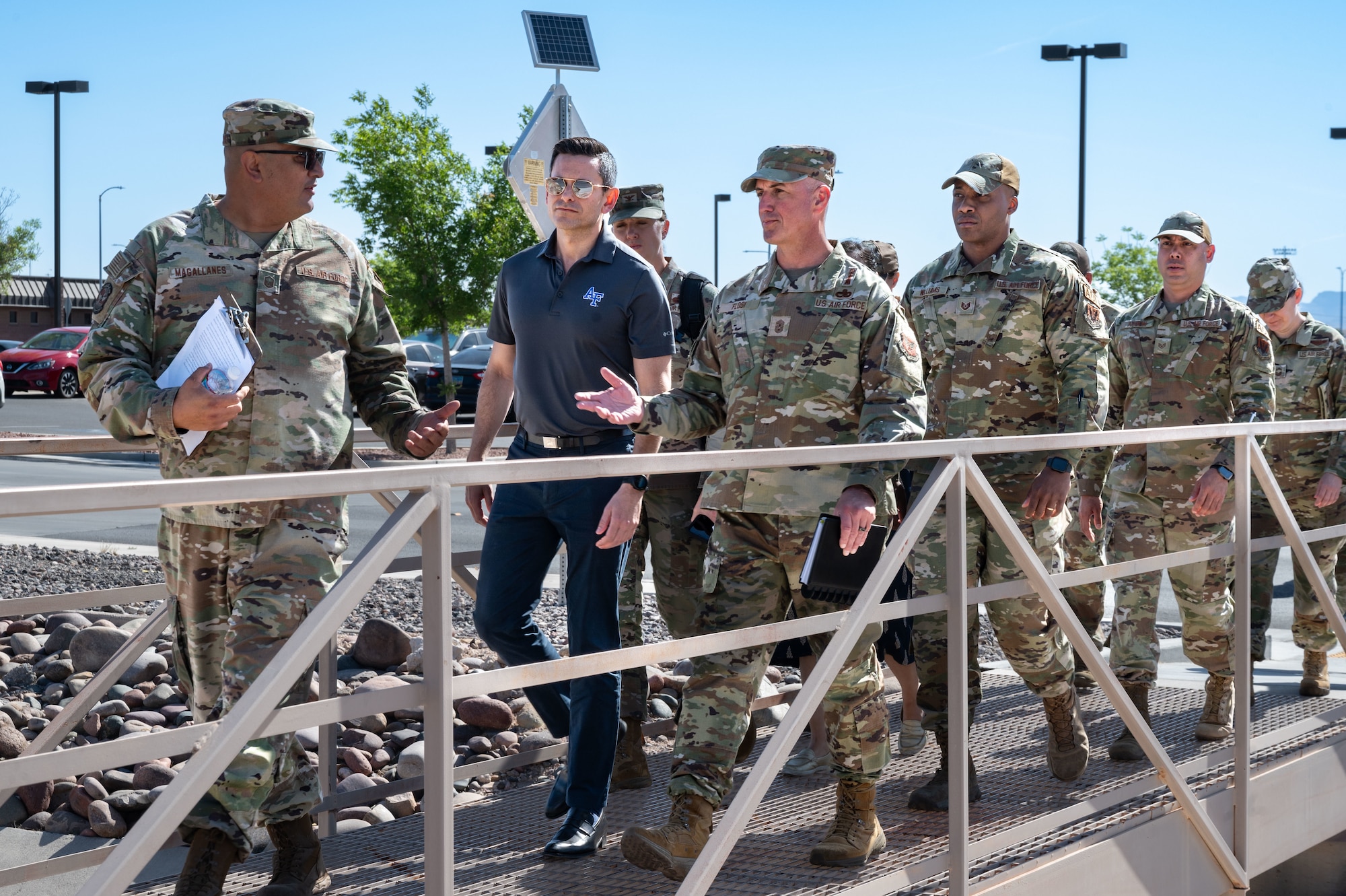 U.S. Air Force Master Sgt. Pedro Magallanes, left, the Airman Dorm Leader Superintendent assigned to the 99th Civil Engineer Squadron, gives a tour to the Honorable Alex Wagner, Assistant Secretary of the Air Force for Manpower and Reserve Affairs, and Chief Master Sgt. of the Air Force David Flosi during a visit to Nellis Air Force Base (AFB), Nevada, May 7, 2024.